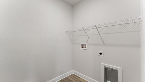Laundry room with ventilated shelving.
