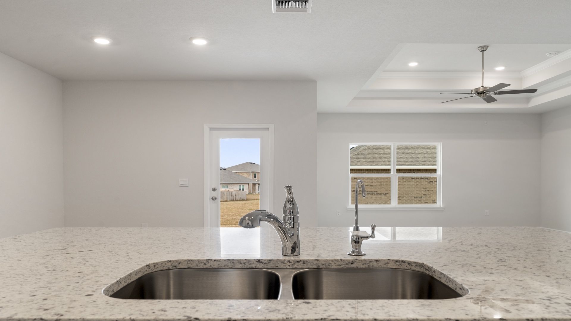 Kitchen island with granite countertops and undermount sink.