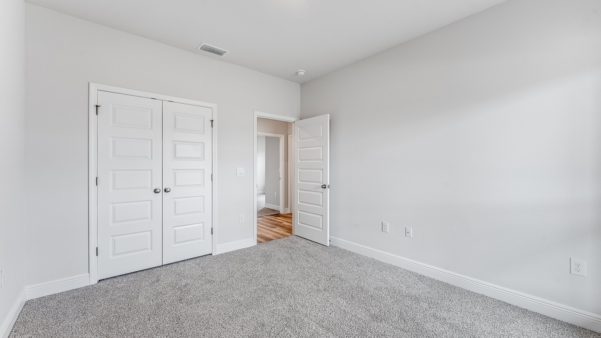 Bedroom with carpet floors and closet.