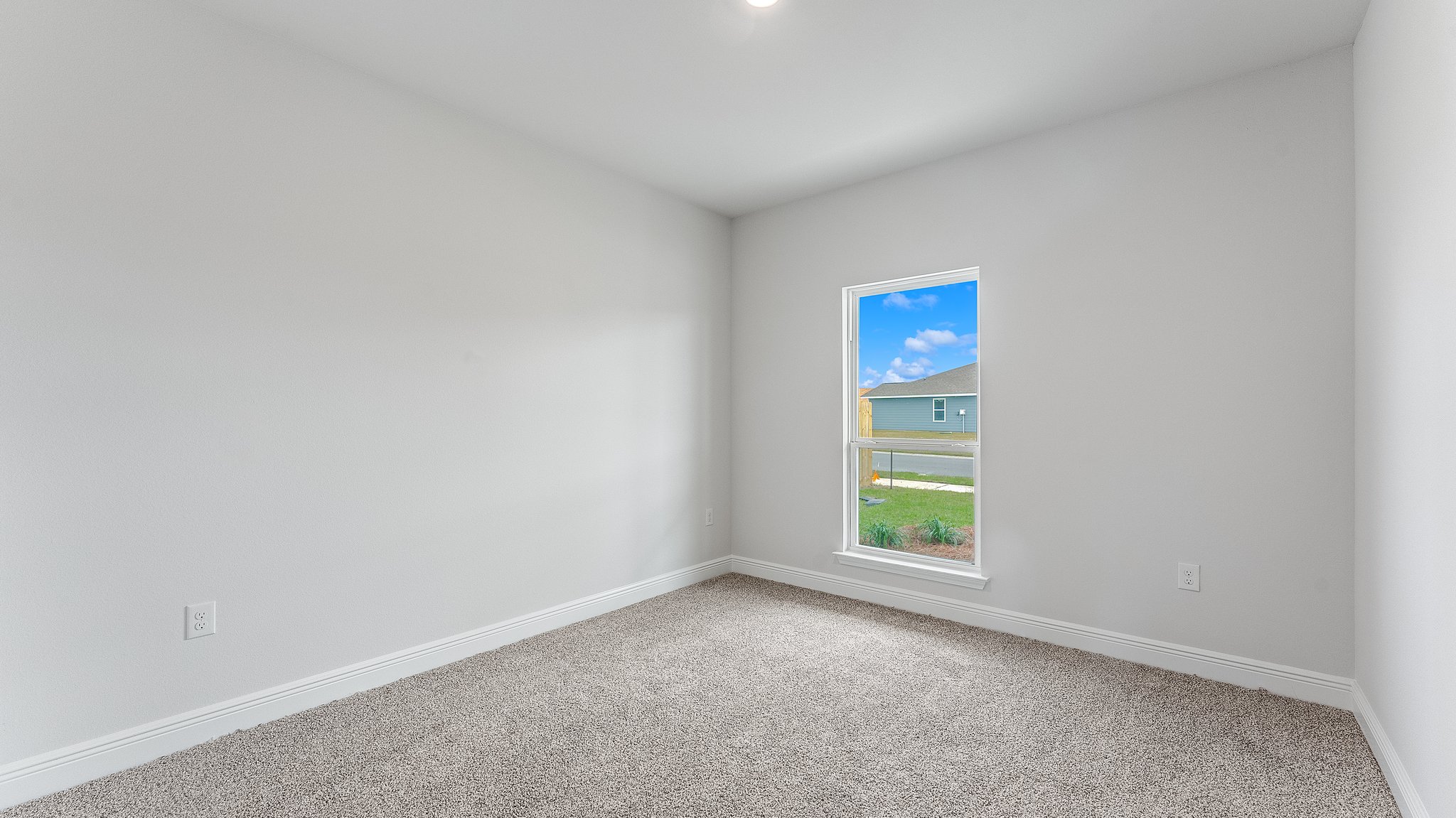 Bedroom with carpet floors and window.