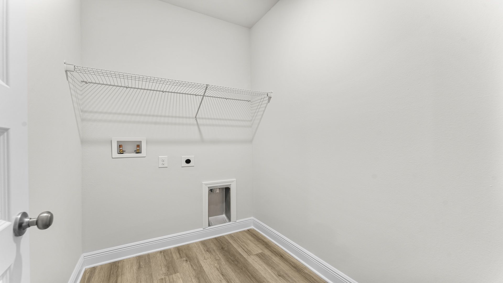 Laundry room with EVP flooring and ventilated shelving.