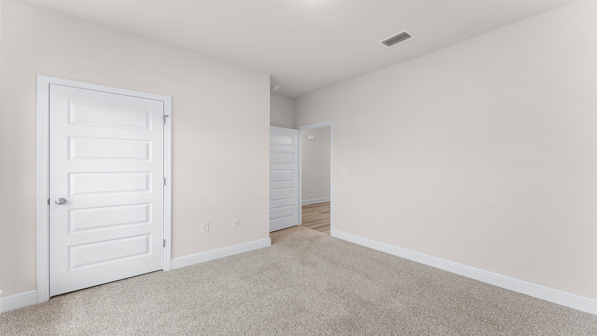 Bedroom with carpet floors and closet.