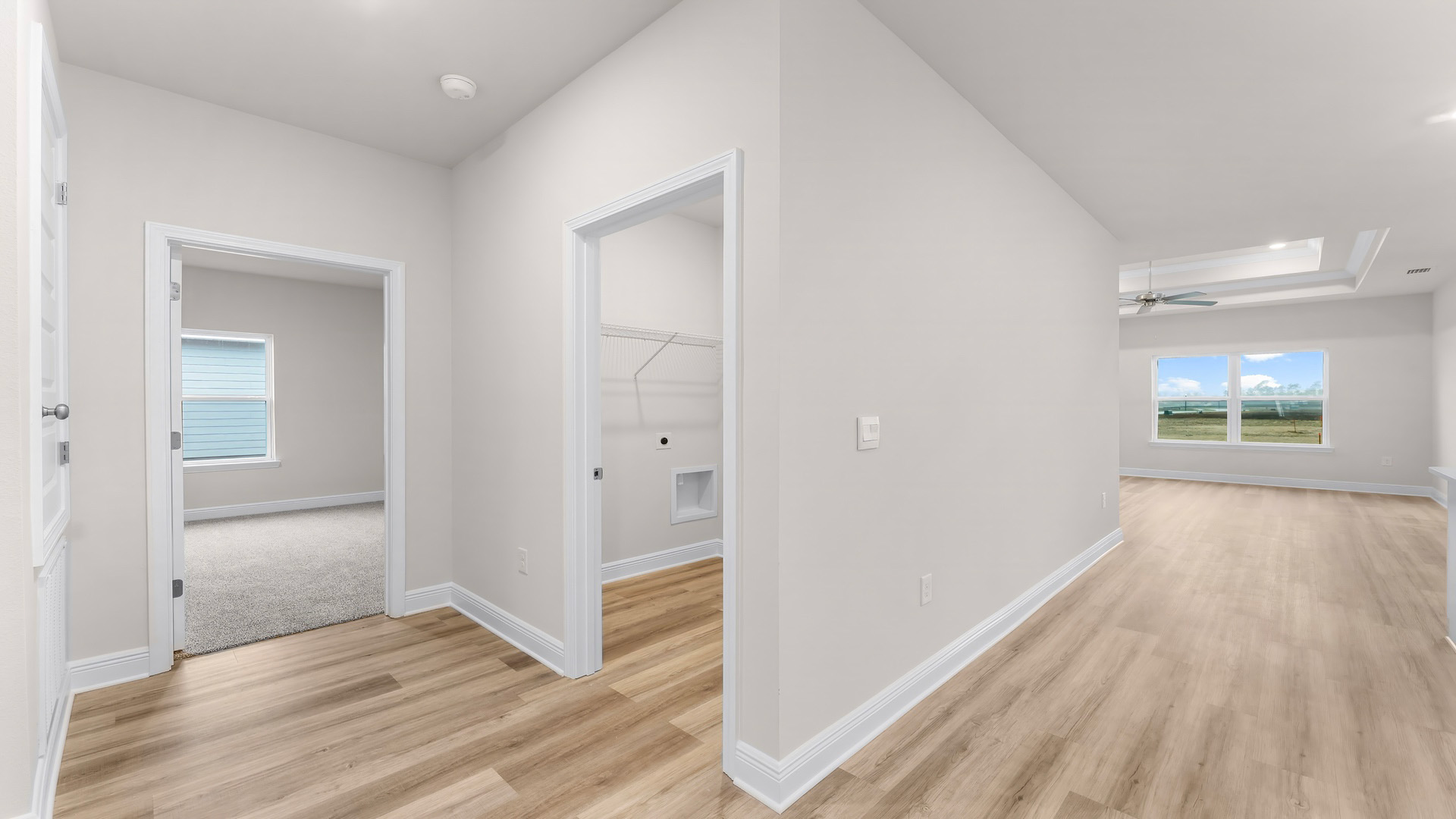 Hallway by garage entrance and bedroom and laundry room.