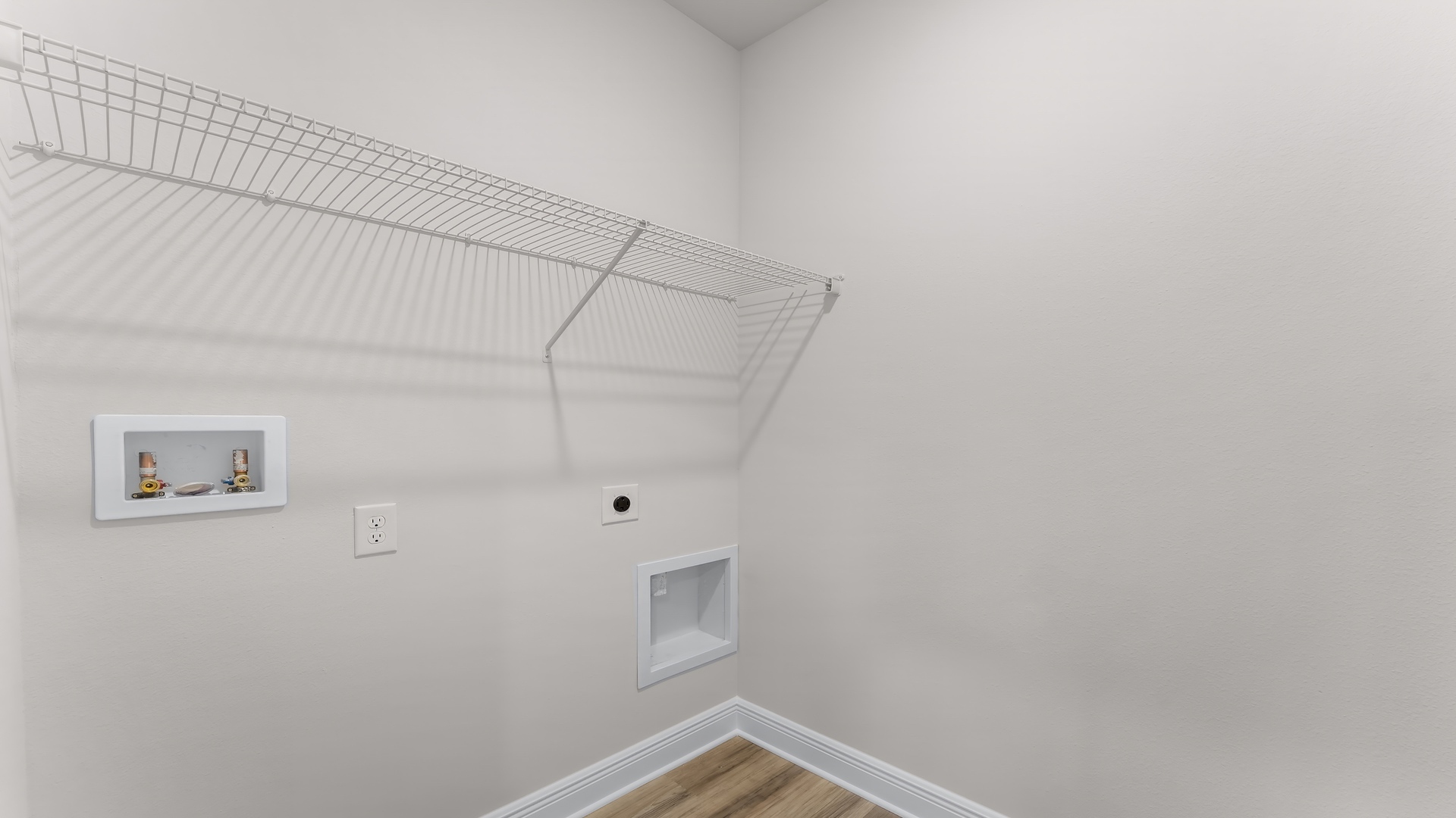 Laundry room with EVP flooring and ventilated shelving.