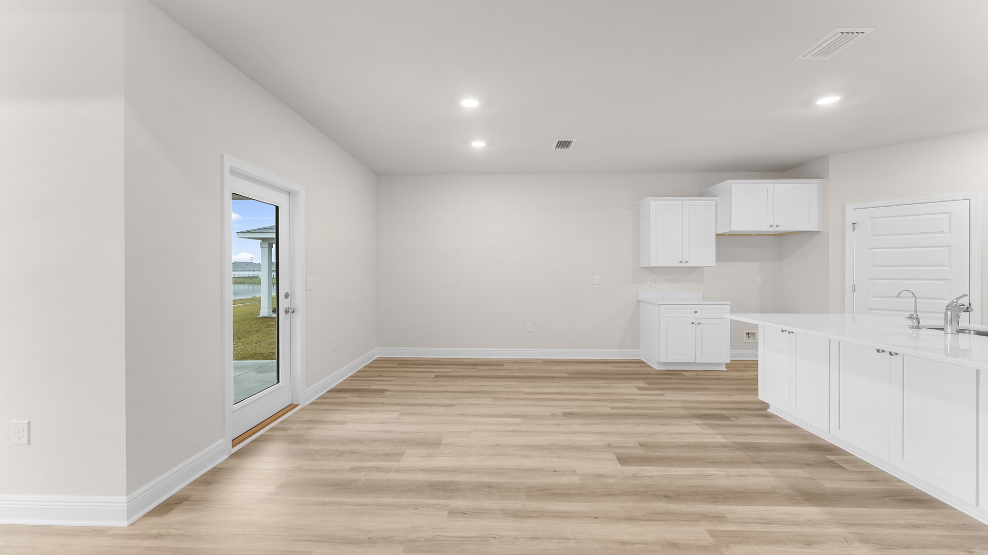 Dining area with EVP flooring and back door.
