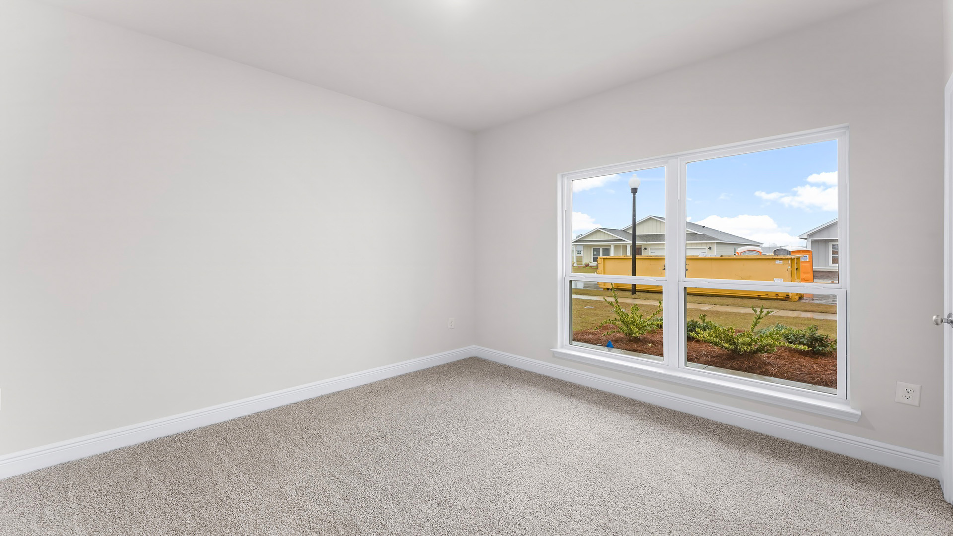 Bedroom with carpet floors and windows.