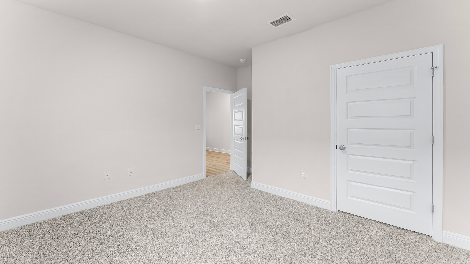 Bedroom with carpet floors and closet.