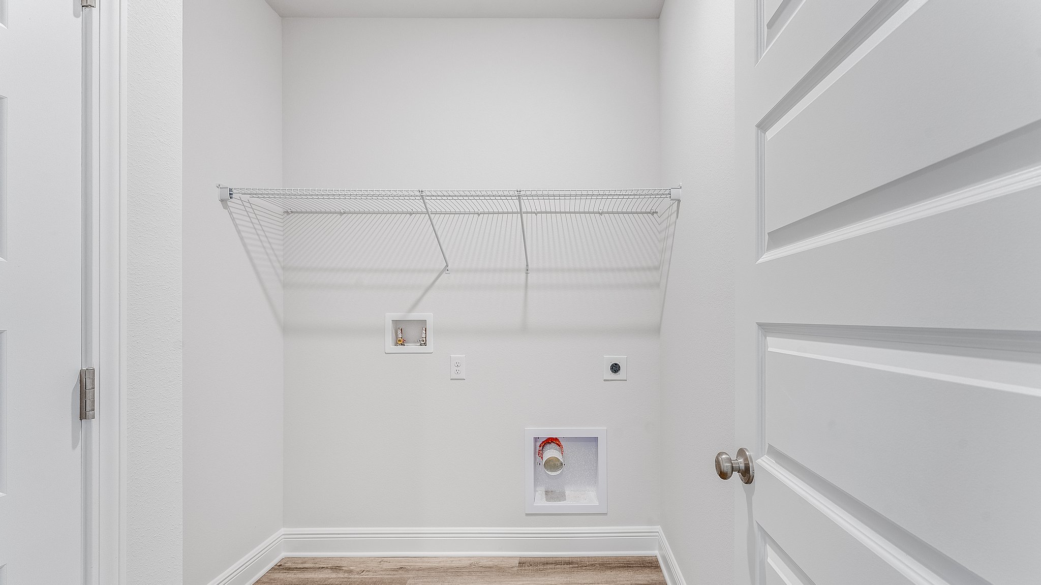 Laundry room with EVP flooring and ventilated shelving.