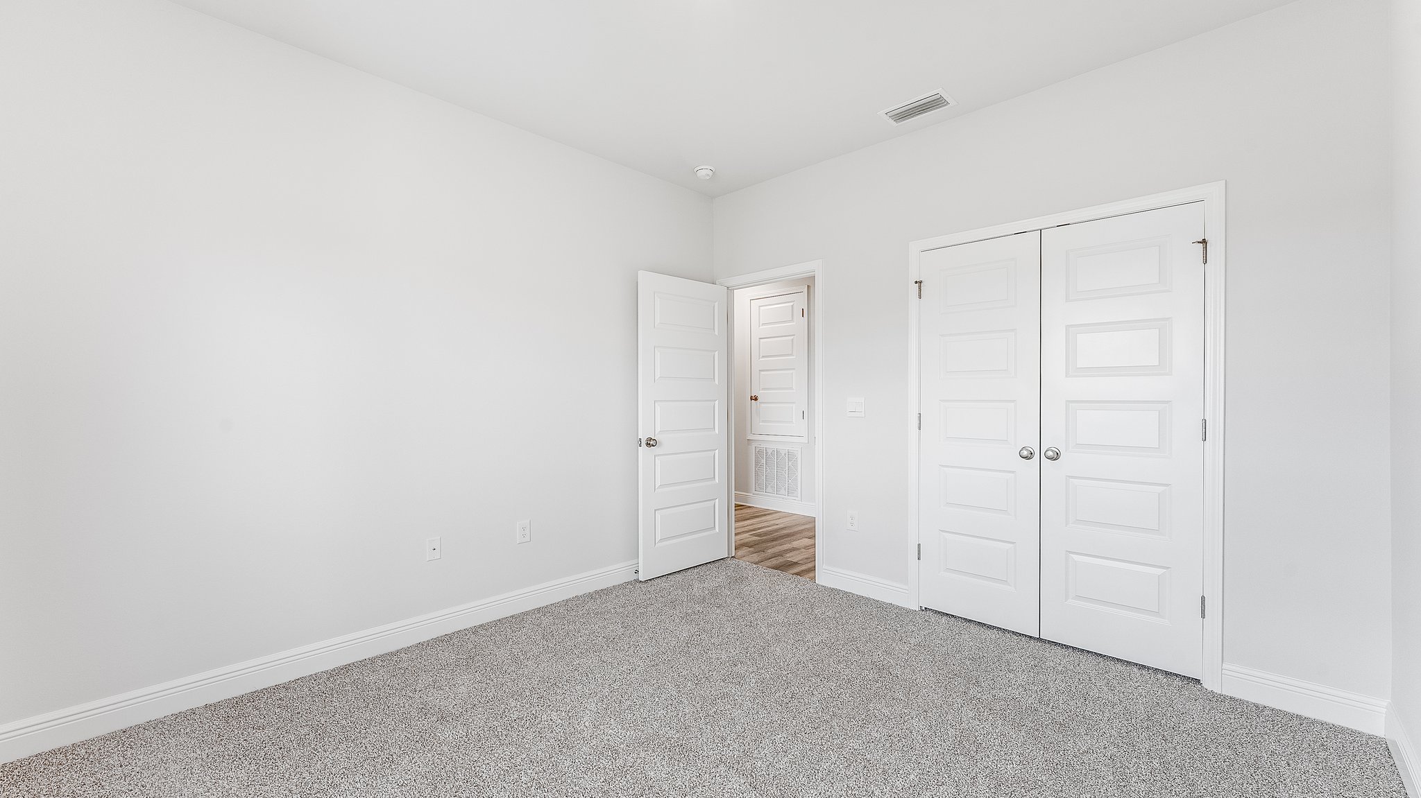 Bedroom with carpet floors and closet.