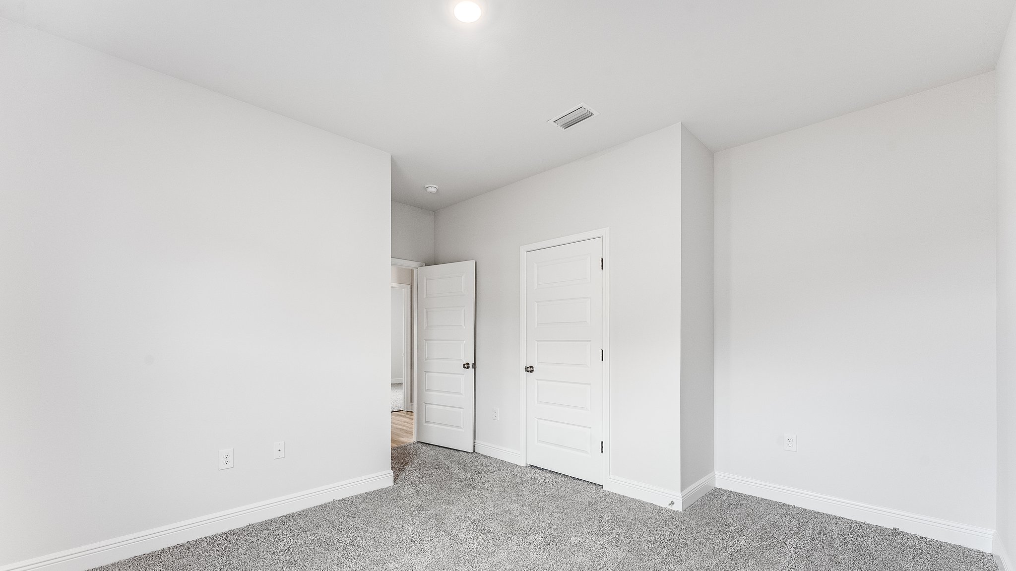 Bedroom with carpet floors and closet.