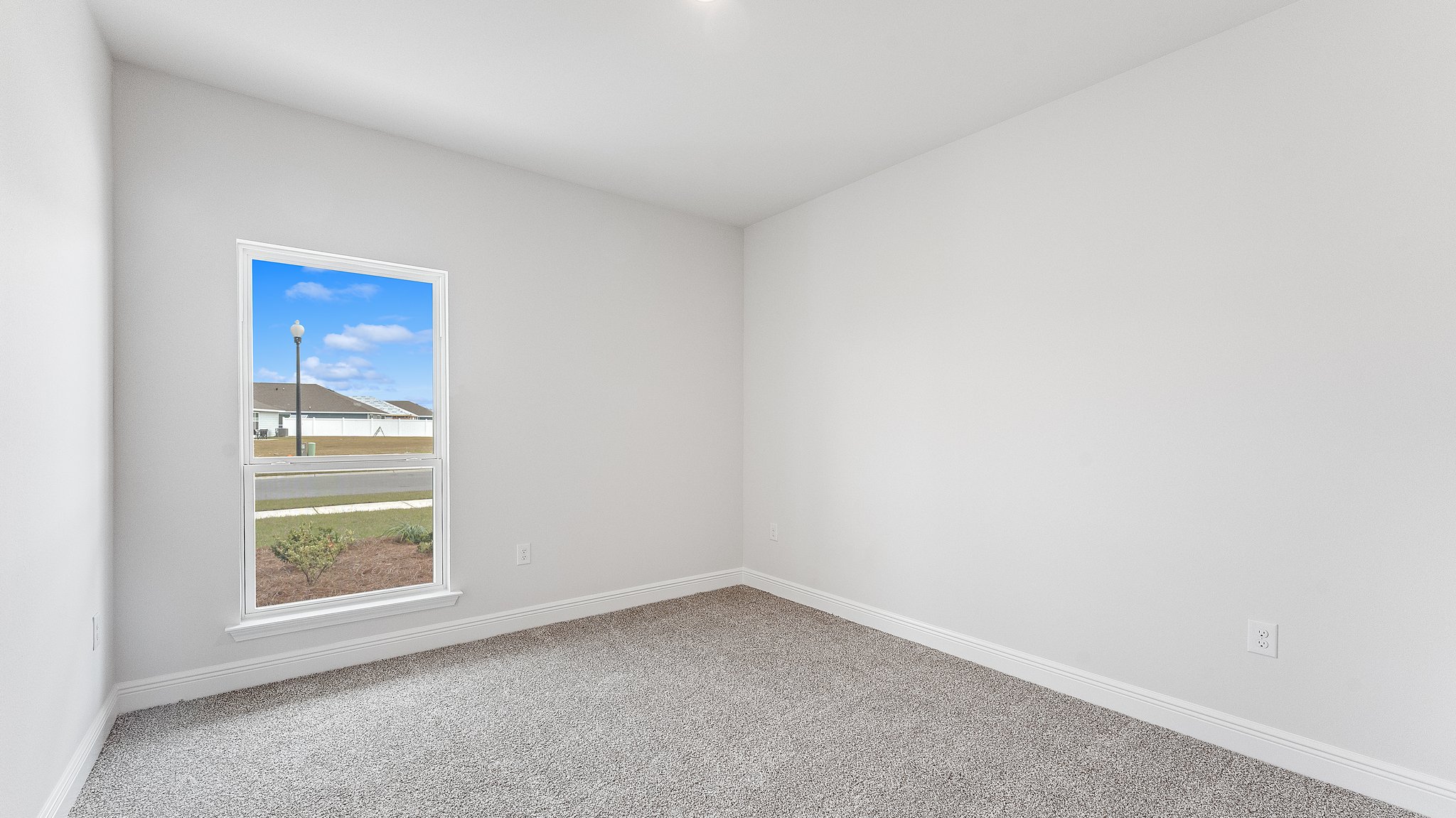 Bedroom with carpet floors and window.