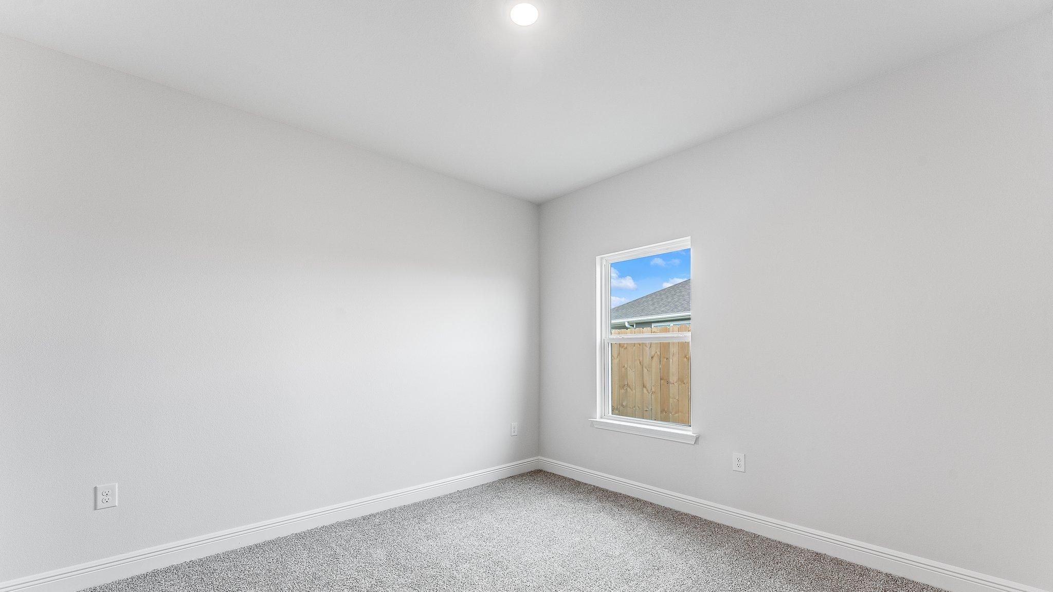 Bedroom with carpet floors and window.