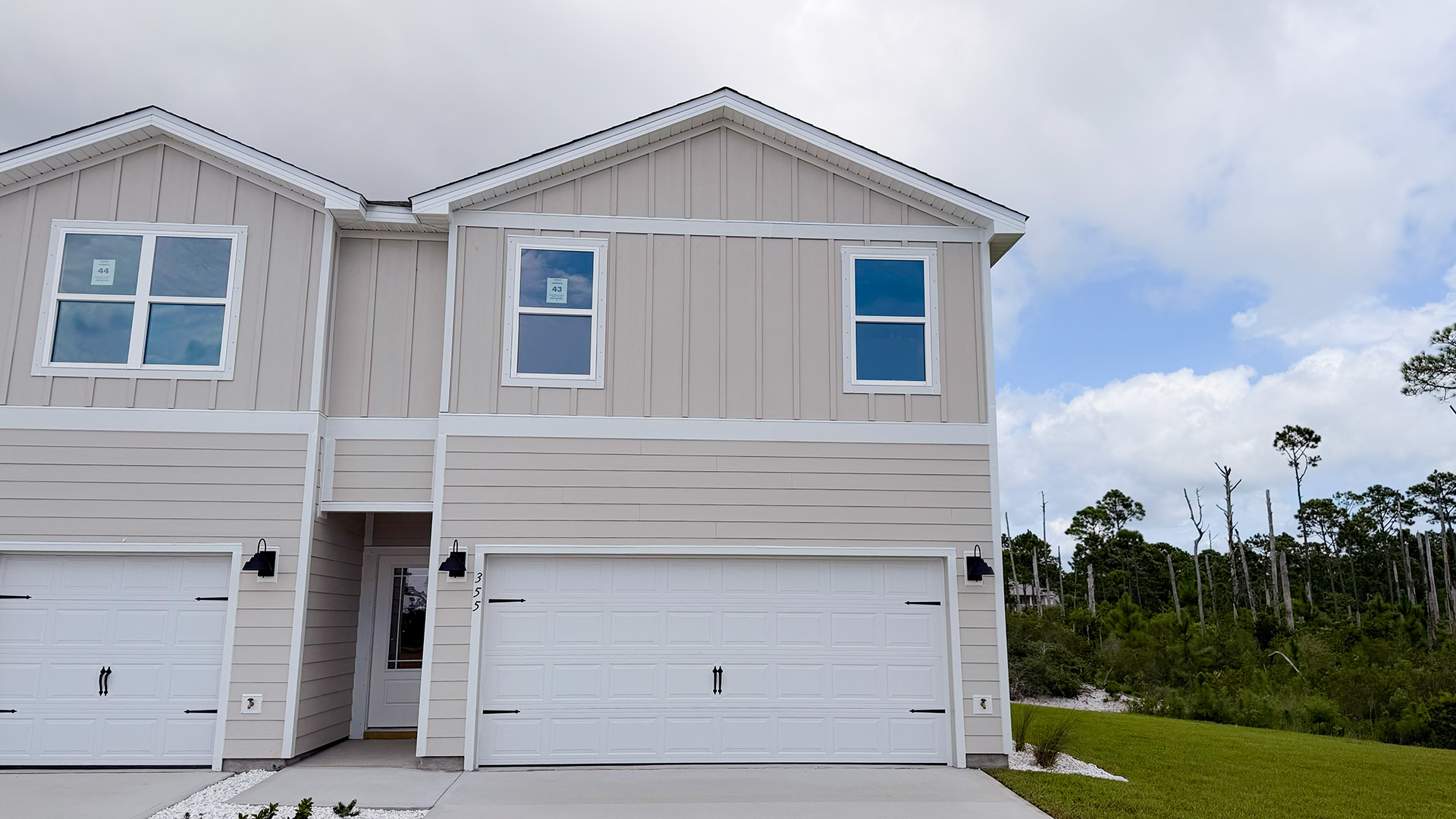 Sabal Townhome exterior unit at WindMark Beach with Hardie Board siding and two car garage.
