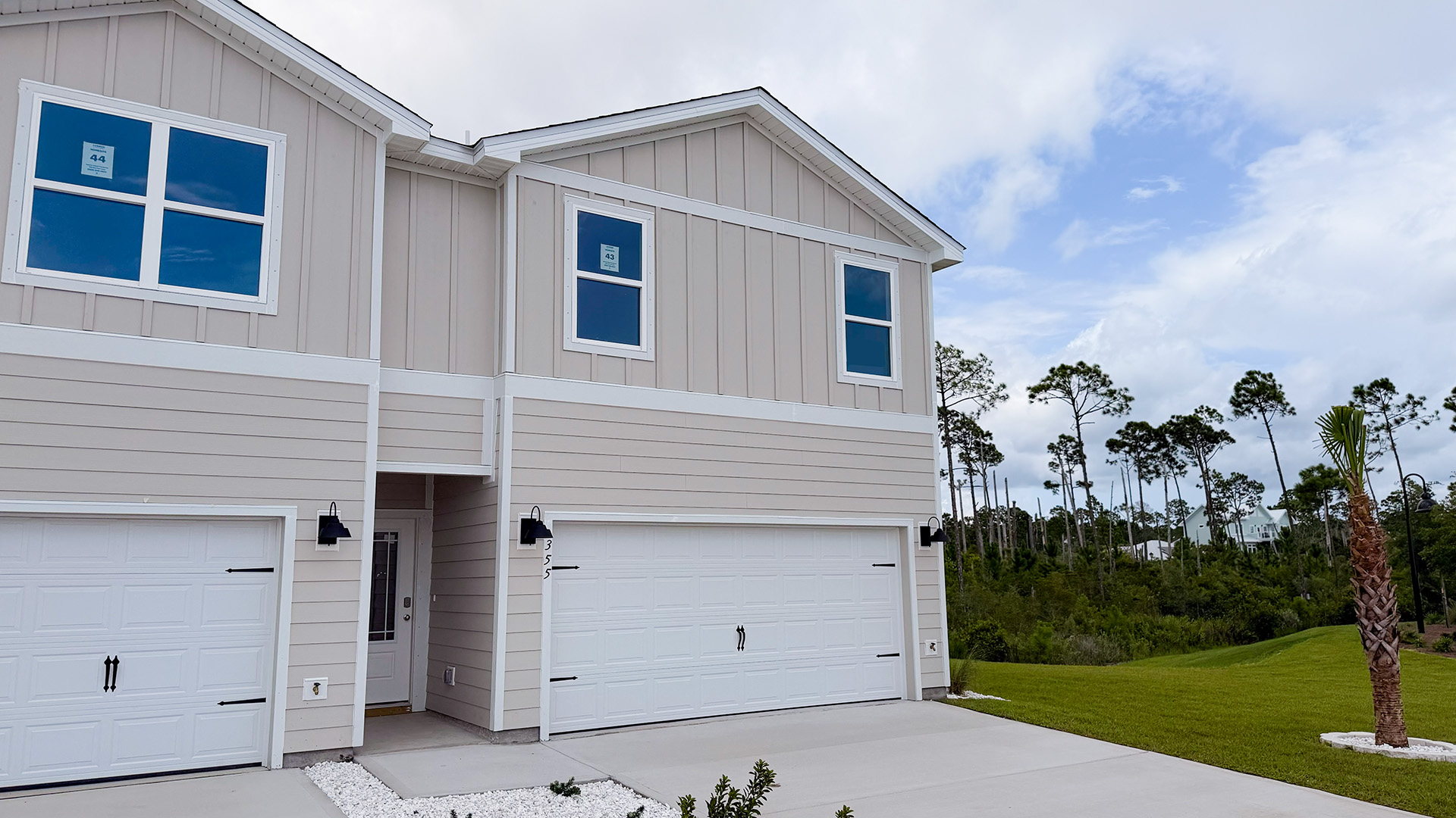 Sabal Townhome exterior unit at WindMark Beach with Hardie Board siding and two car garage.