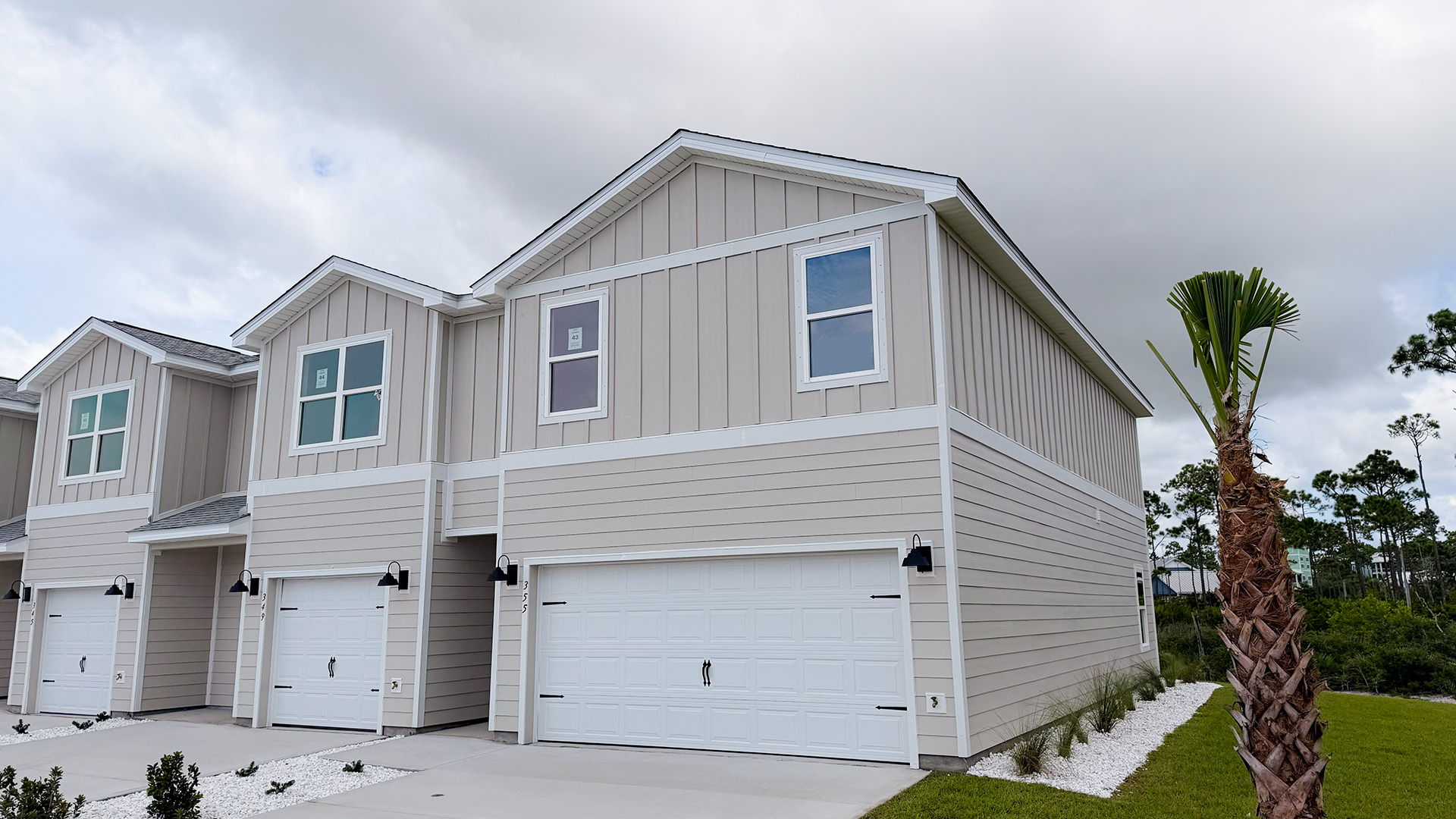 Sabal Townhome exterior unit at WindMark Beach with Hardie Board siding and two car garage.
