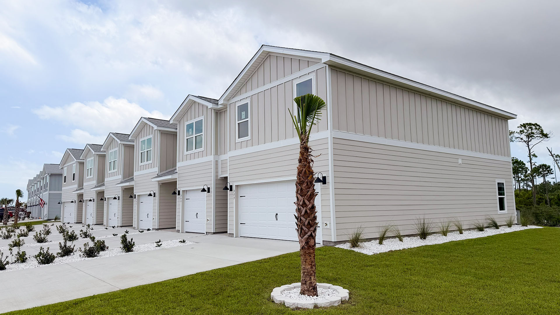 Sabal Townhome exterior unit at WindMark Beach with Hardie Board siding and two car garage.