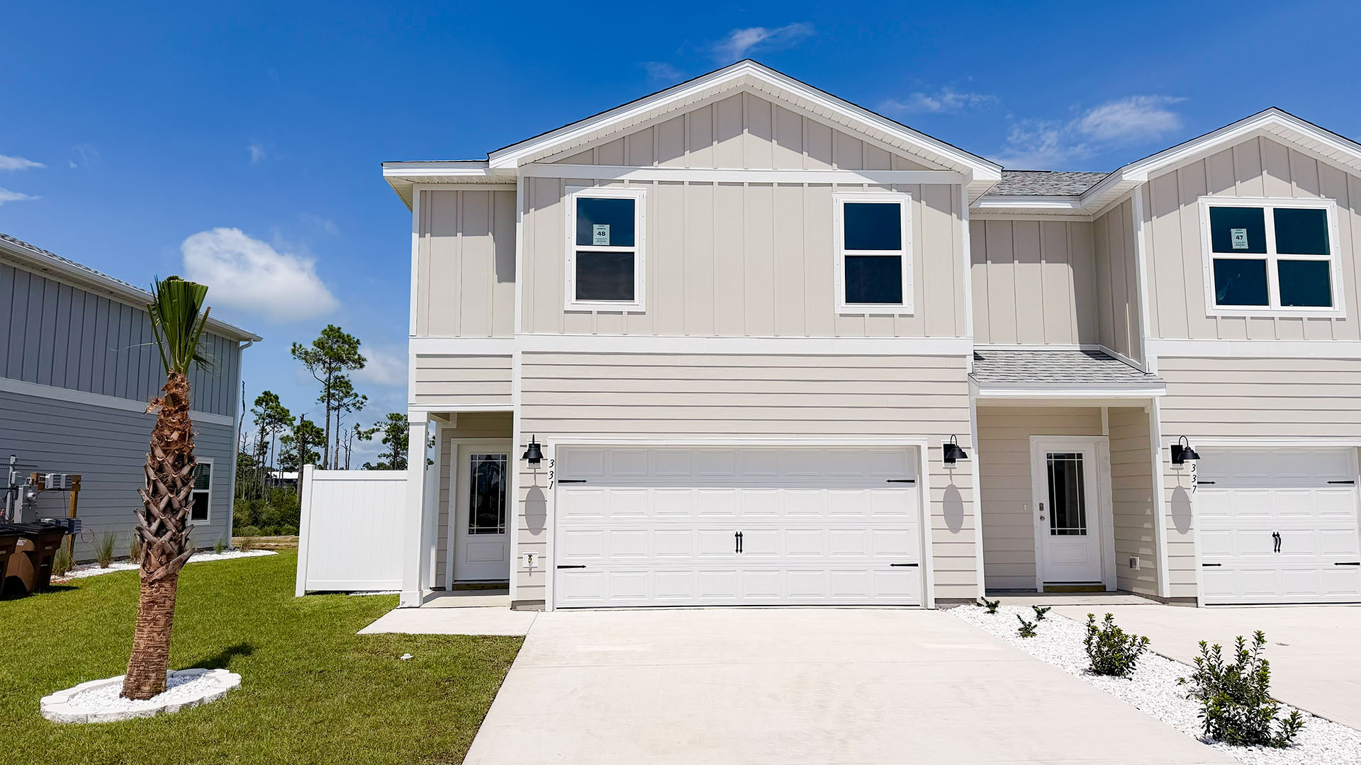 Sabal Townhome exterior unit at WindMark Beach with Hardie Board siding and two car garage.