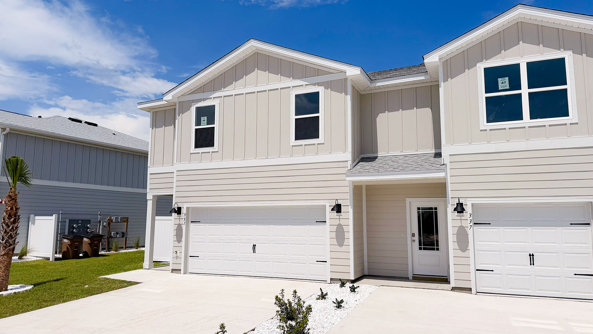 Sabal Townhome exterior unit at WindMark Beach with Hardie Board siding and two car garage.