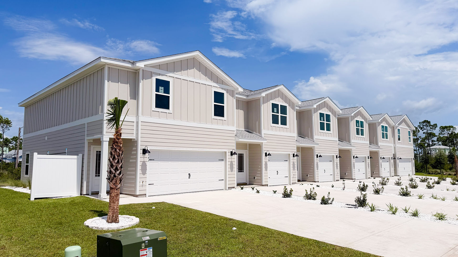 Sabal Townhome exterior unit at WindMark Beach with Hardie Board siding and two car garage.