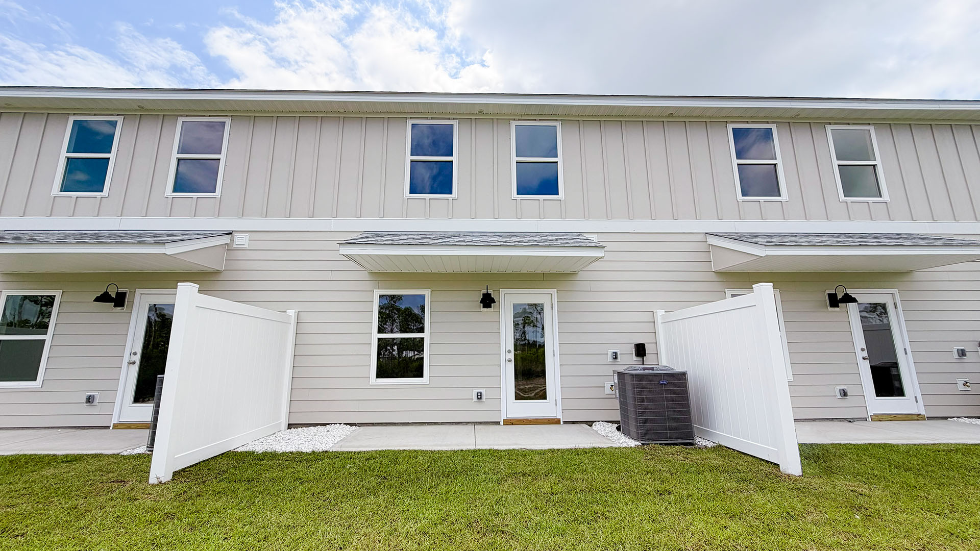 Sabal Townhome units rear of home with covered patios and partitions.