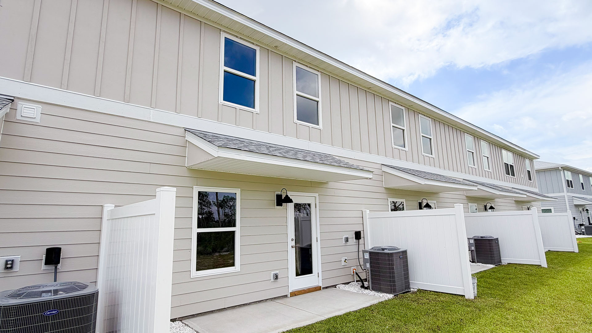 Sabal Townhome units rear of home with covered patios and partitions.