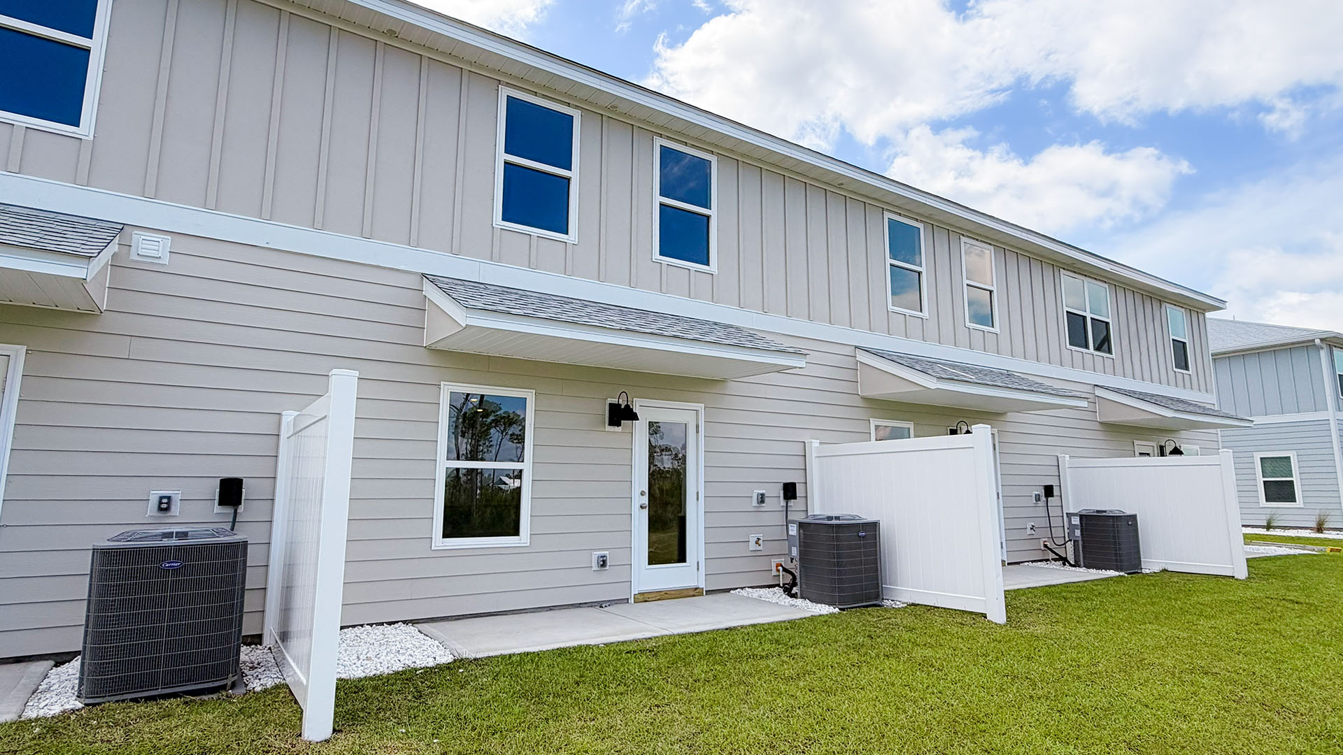 Sabal Townhome units rear of home with covered patios and partitions.