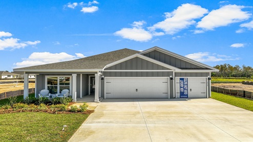 Madison model home at Liberty with 3 car garage and covered front porch.