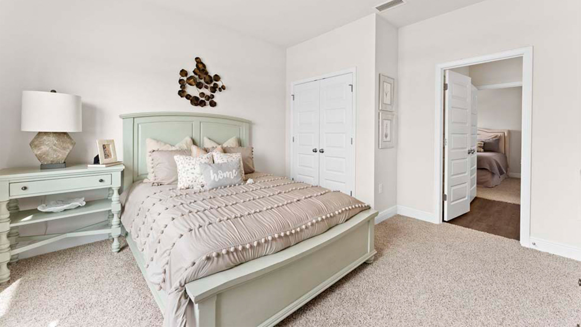 Bedroom with carpet floors and closet and joint bathroom entrance.