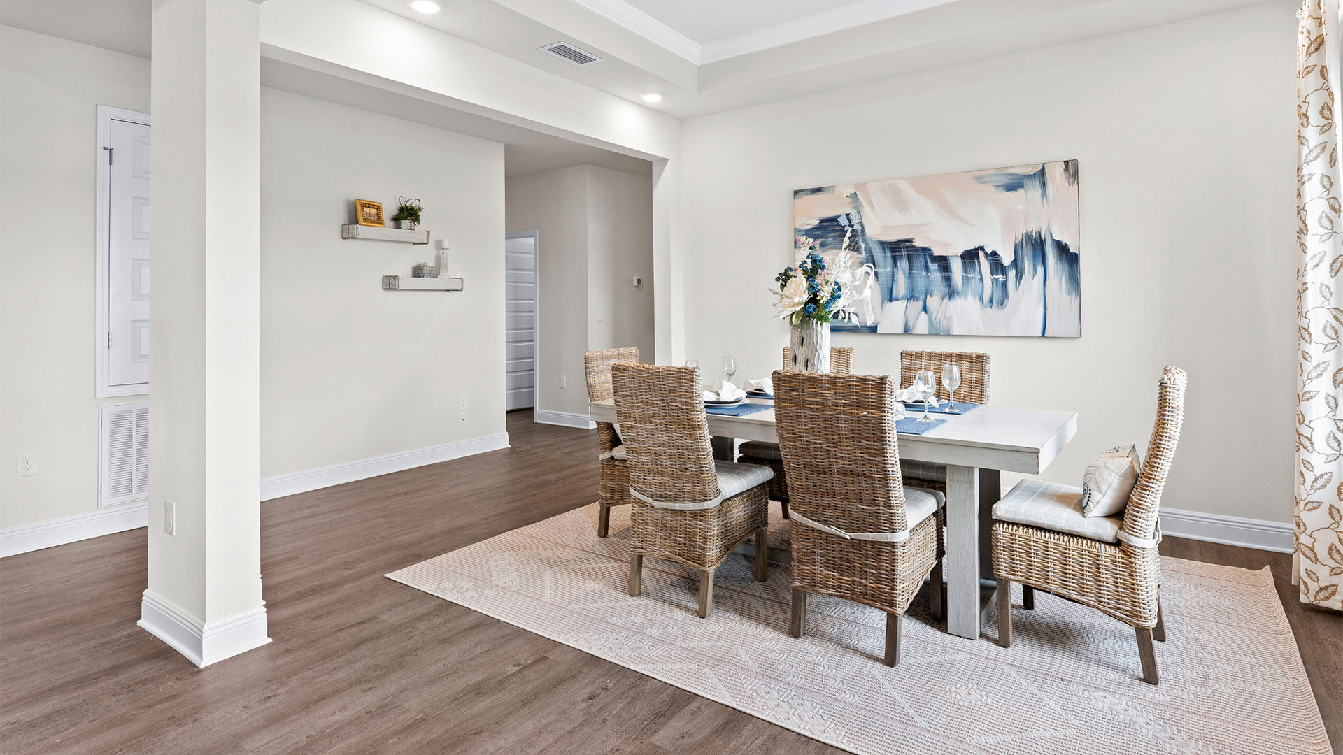 Open dining room with tray ceilings and EVP flooring.