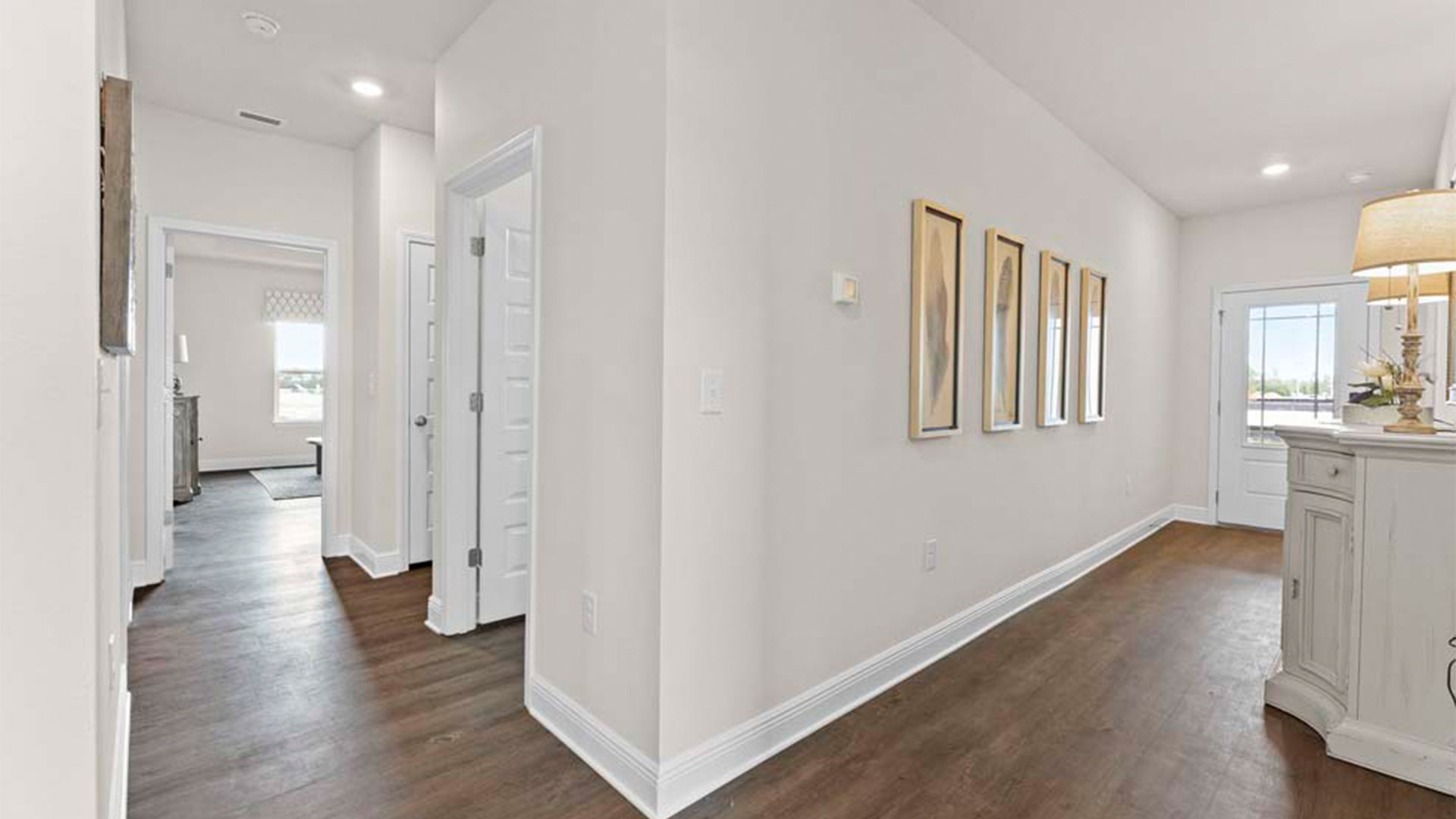 Front hallway next to half bathroom and garage and laundry room with EVP flooring.