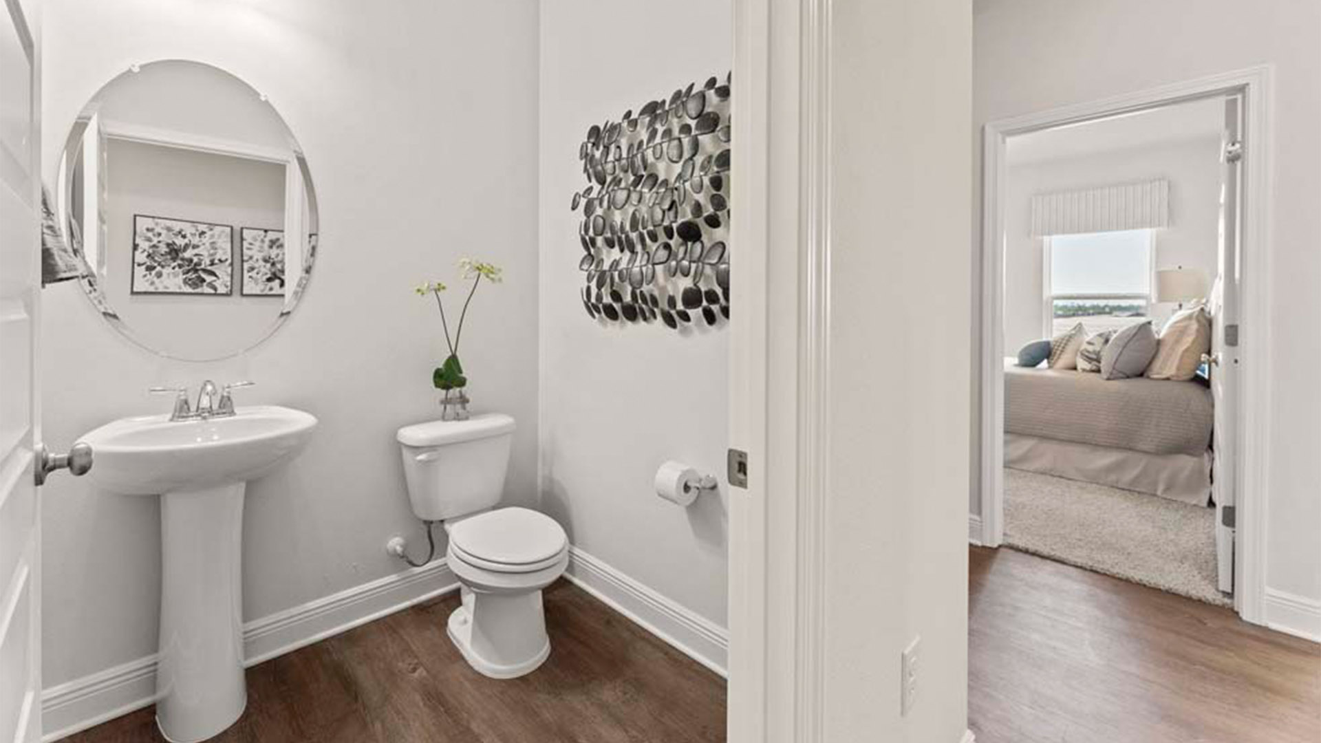 Front hallway next to half bathroom and garage and laundry room with EVP flooring.
