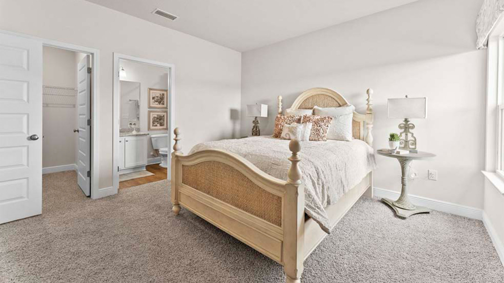 Bedroom with carpet floors and bathroom and closet.