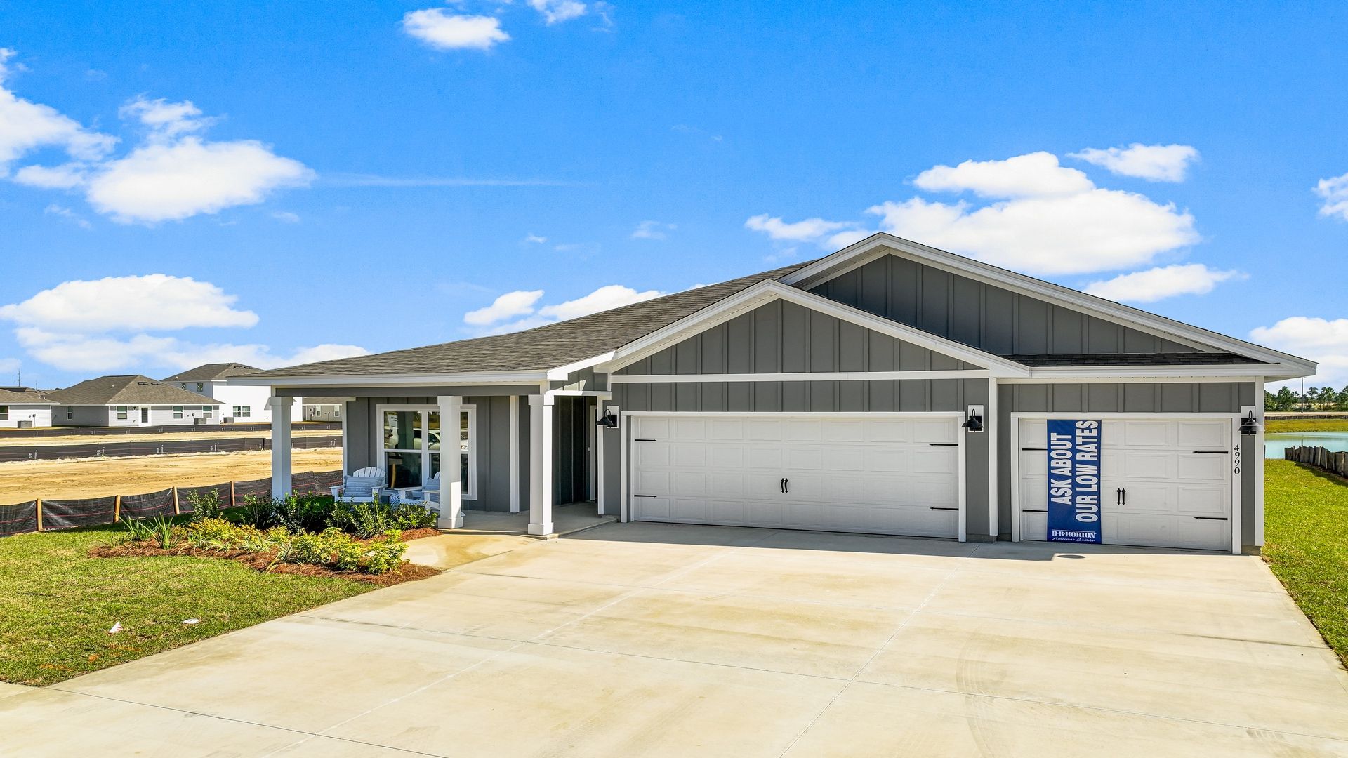 Madison floor plan with 3 car garage and covered front porch.