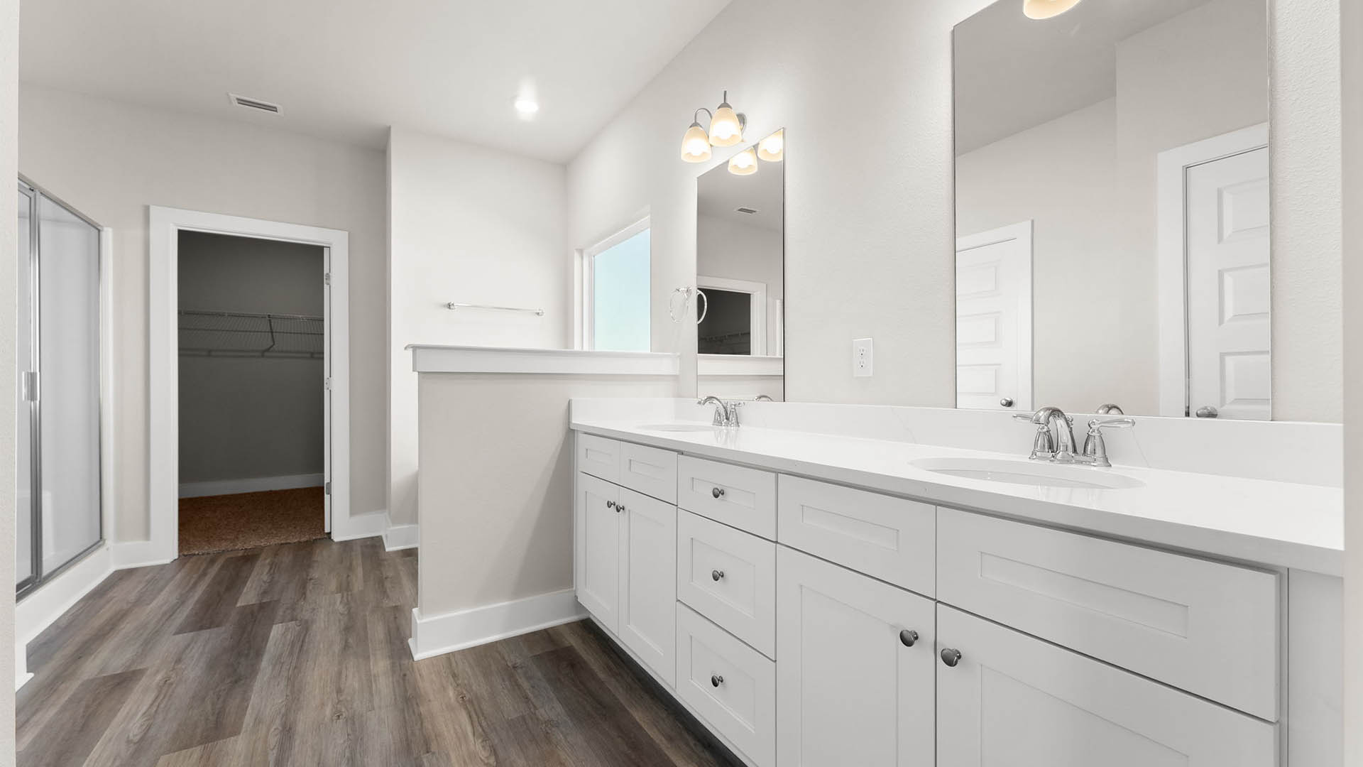 Bathroom with quartz countertops and single vanity and white cabinets and EVP flooring and toilet and shower.