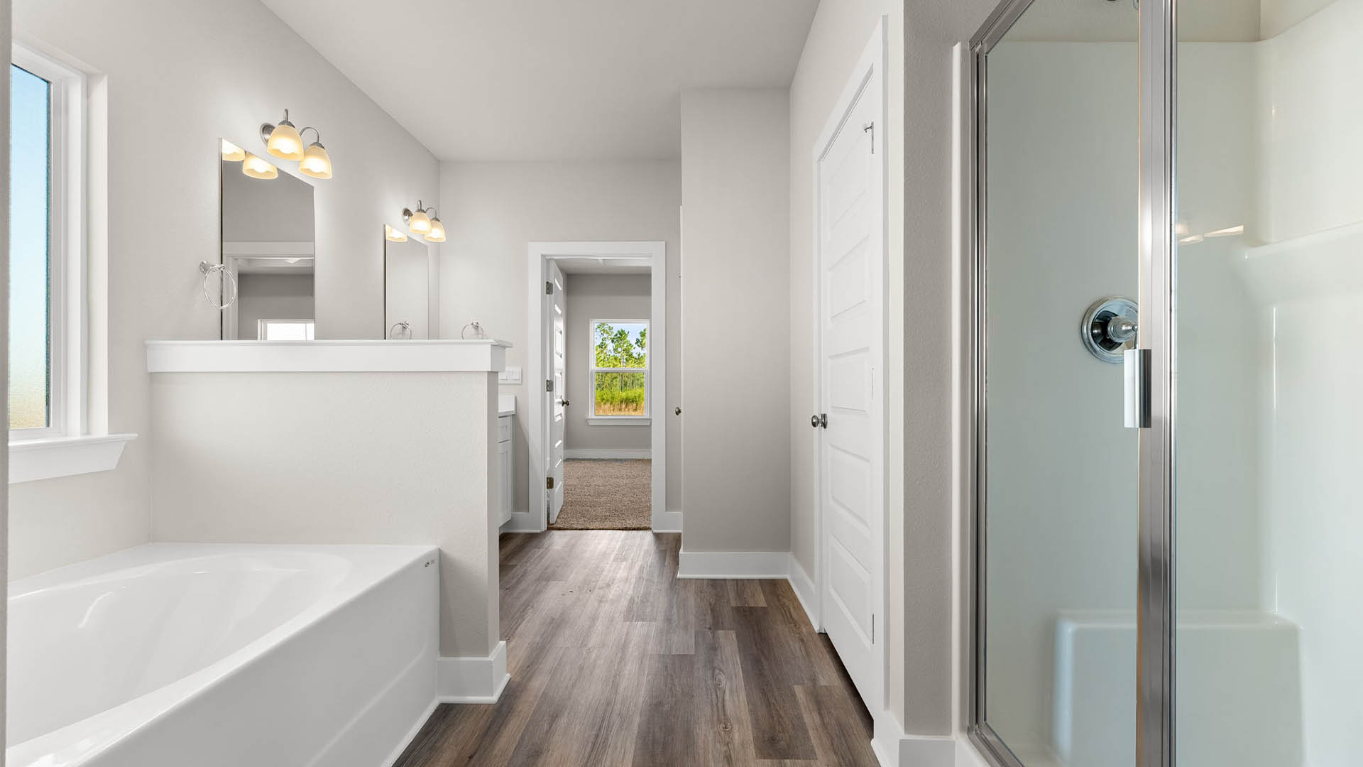 Bathroom with quartz countertops and single vanity and white cabinets and EVP flooring and toilet and shower.