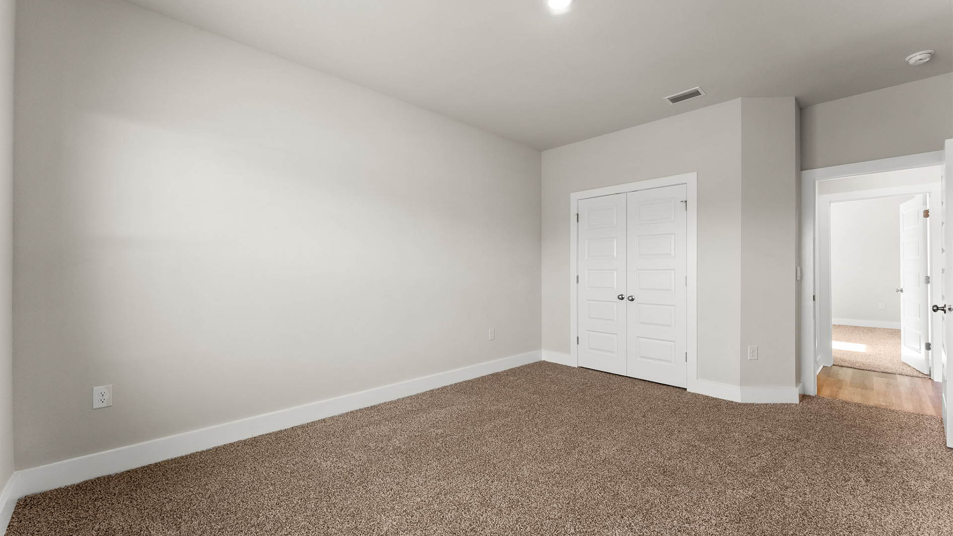 Bedroom with carpet floors and closet.
