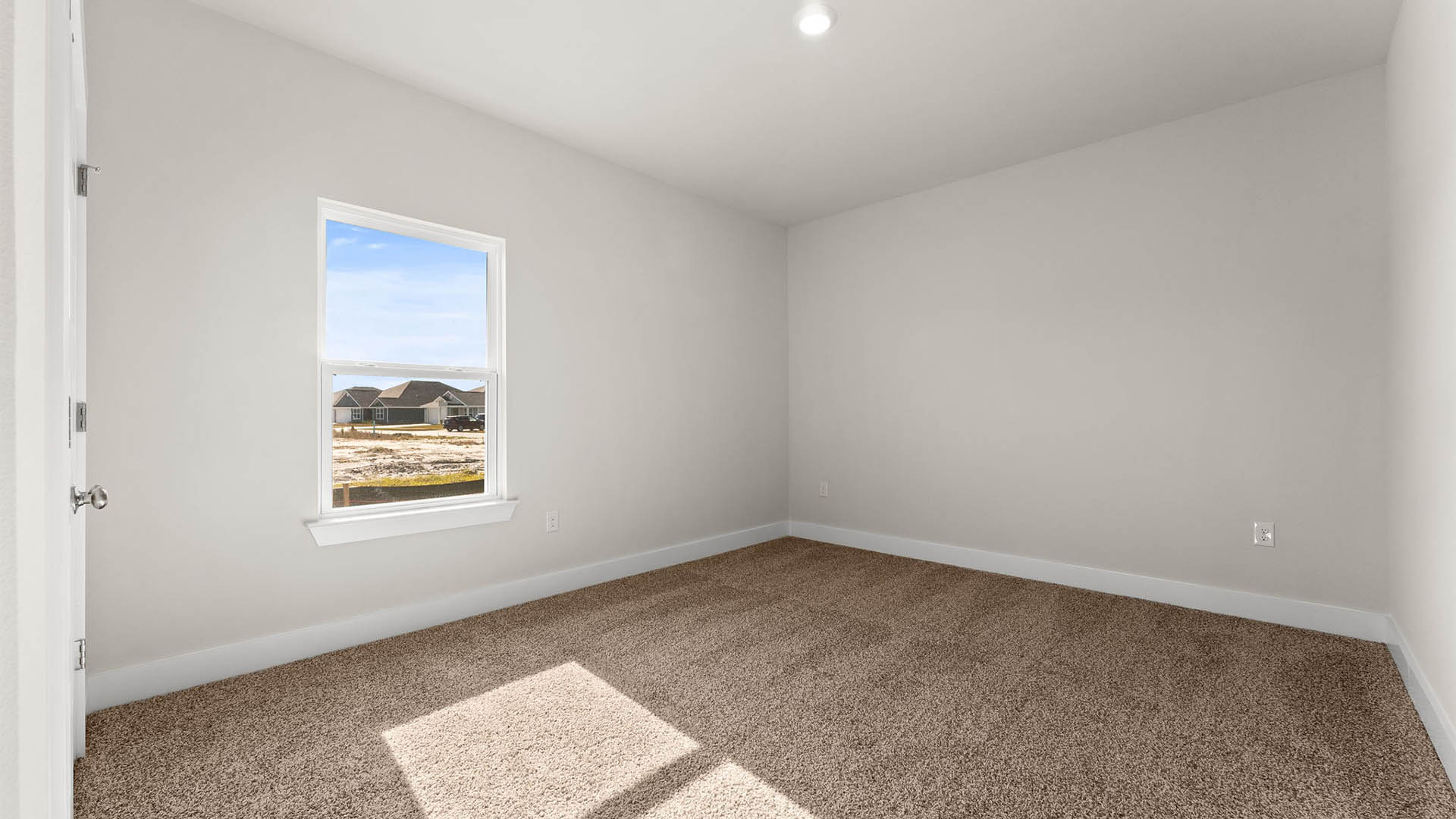 Bedroom with carpet floors and window.