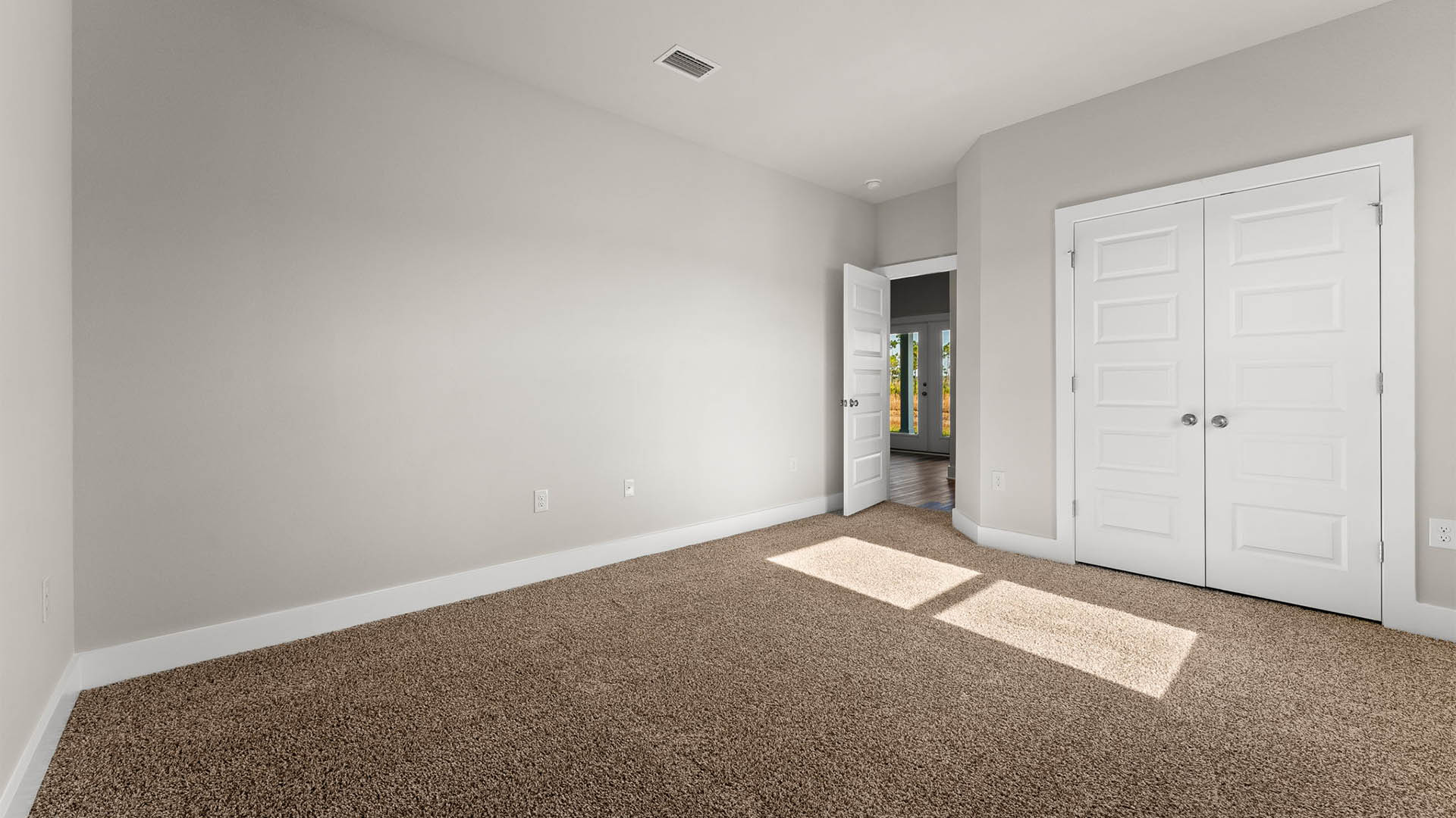 Bedroom with carpet floors and closet.