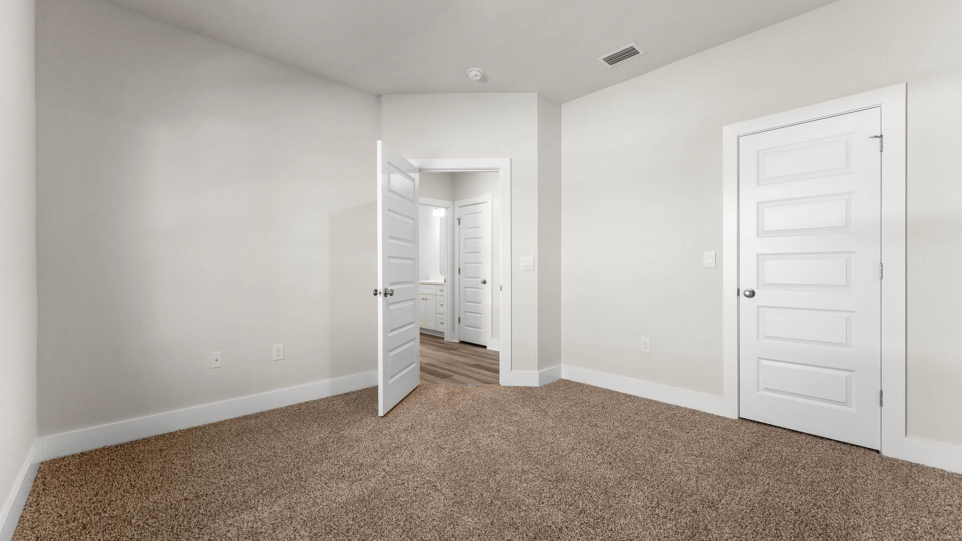 Bedroom with carpet floors and closet.