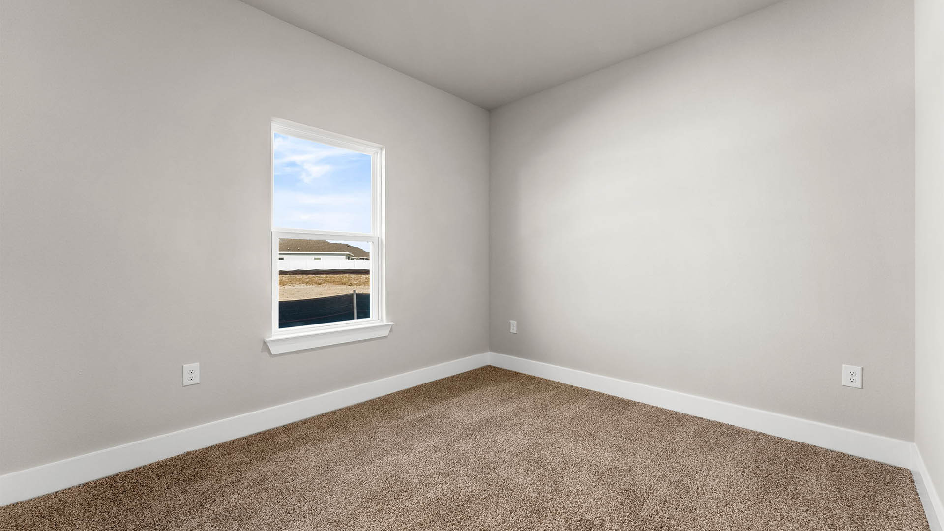 Bedroom with carpet floors and window.