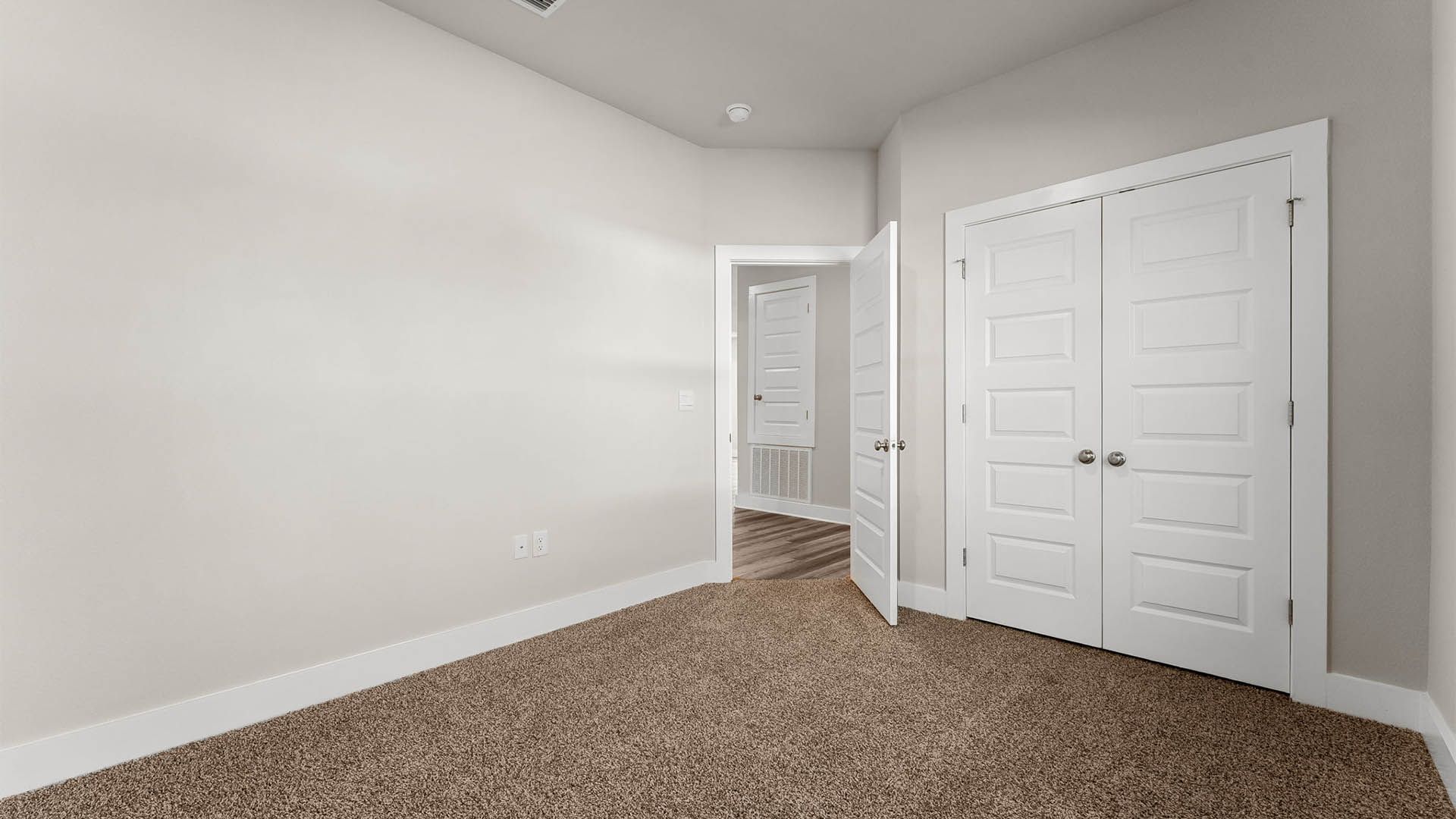 Bedroom with carpet floors and closet.