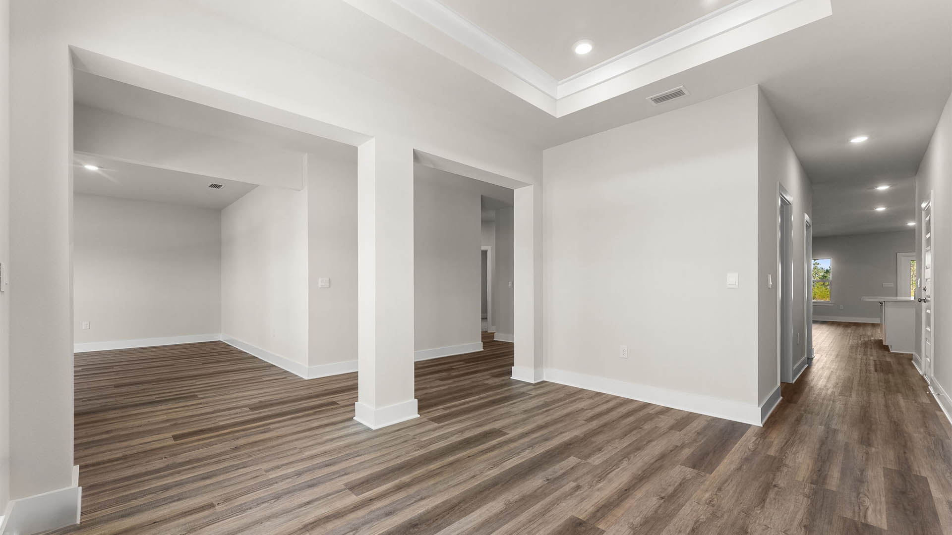 Dining room with EVP flooring and tray ceilings.