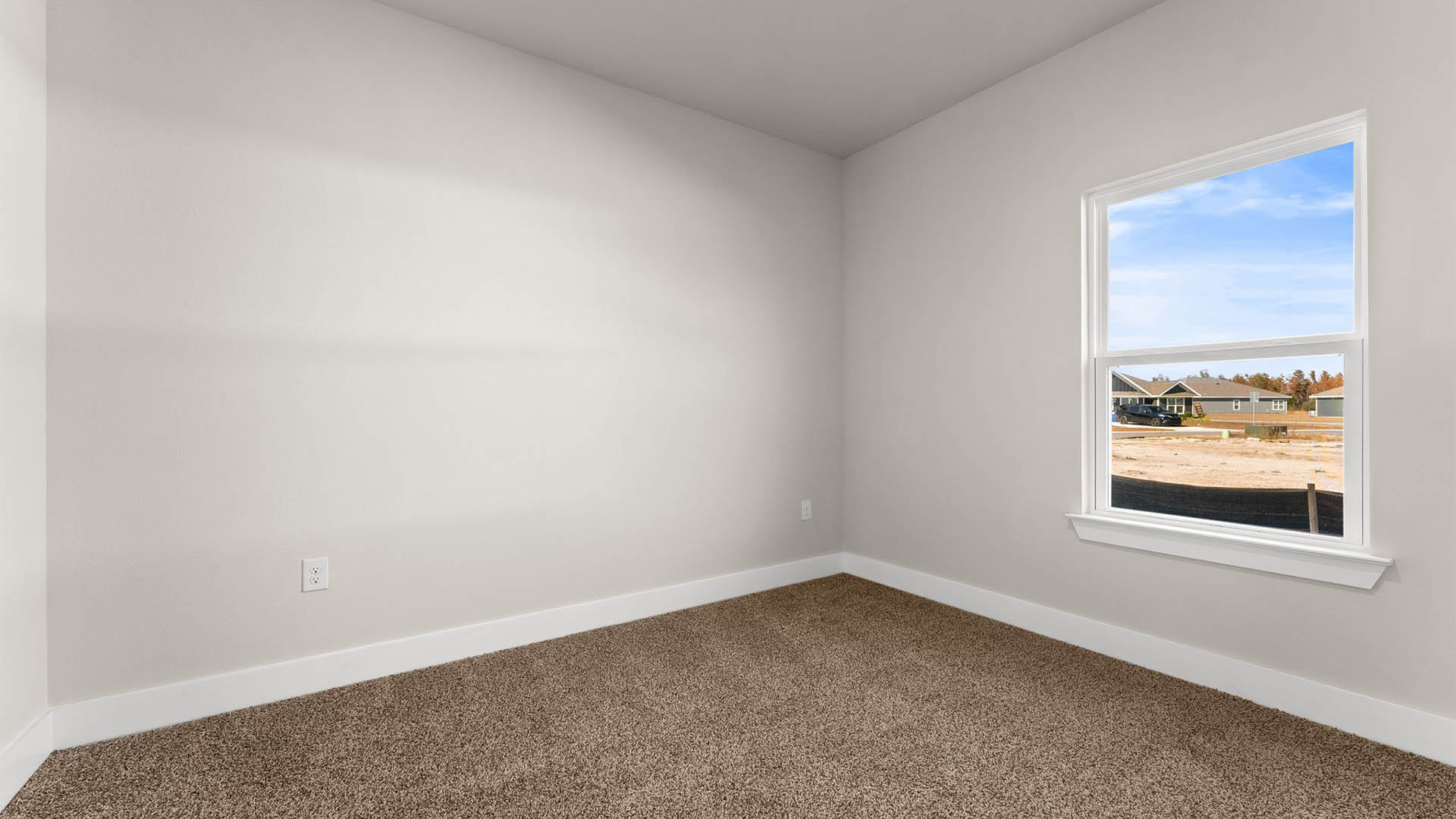 Bedroom with carpet floors and window.