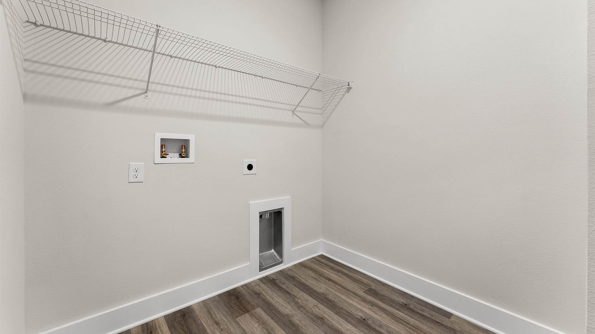 Laundry room with EVP flooring and ventilated shelving.