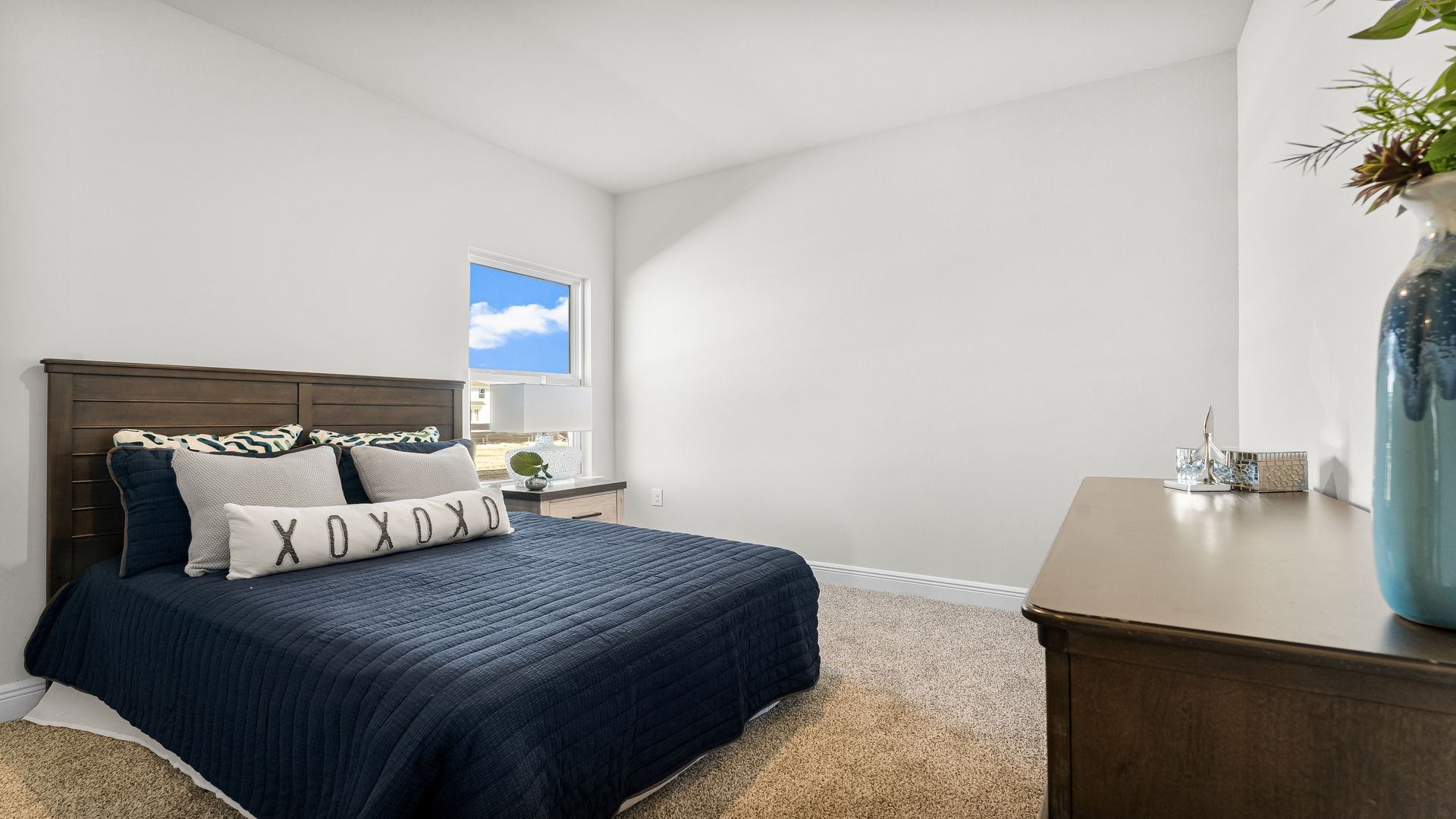 Bedroom with carpet floors and window.