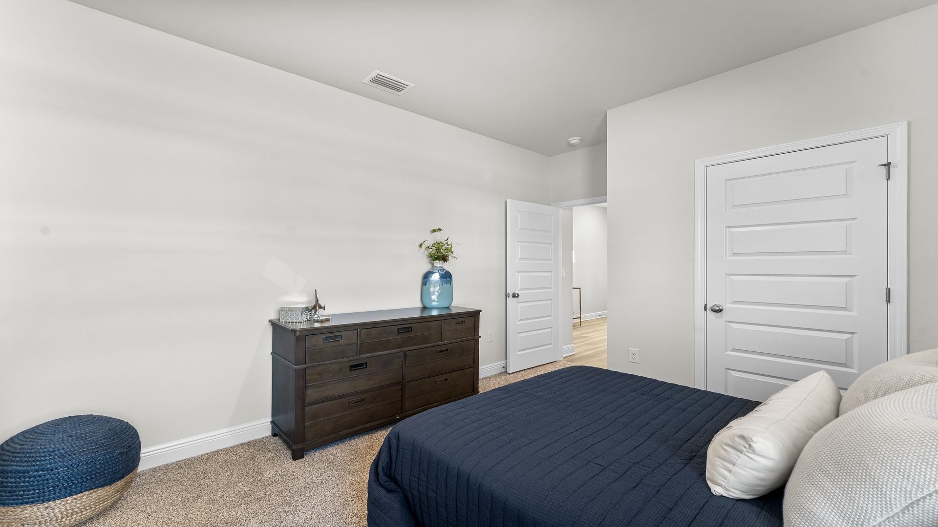 Bedroom with carpet floors and closet.