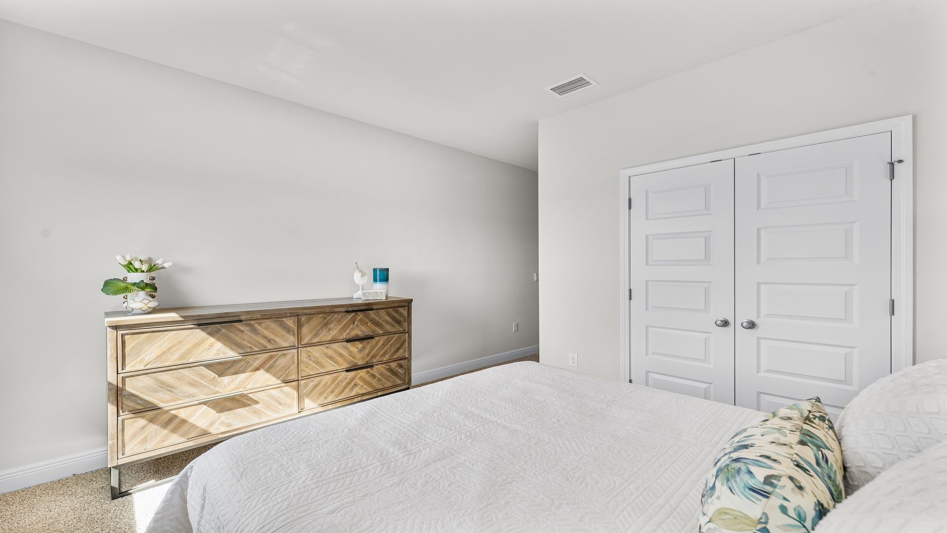 Bedroom with carpet floors and closet.