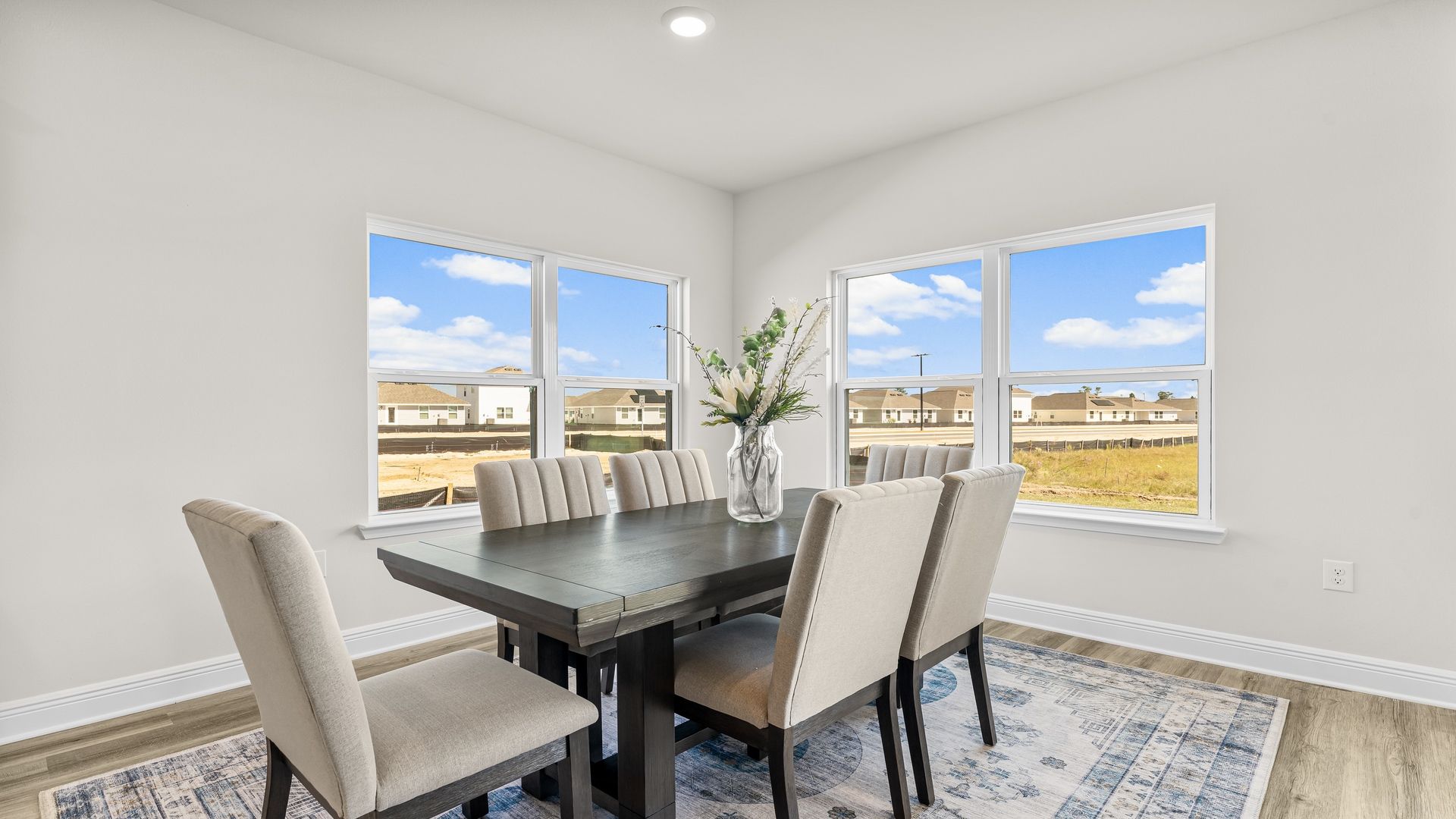 Dining area with double windows and EVP flooring.