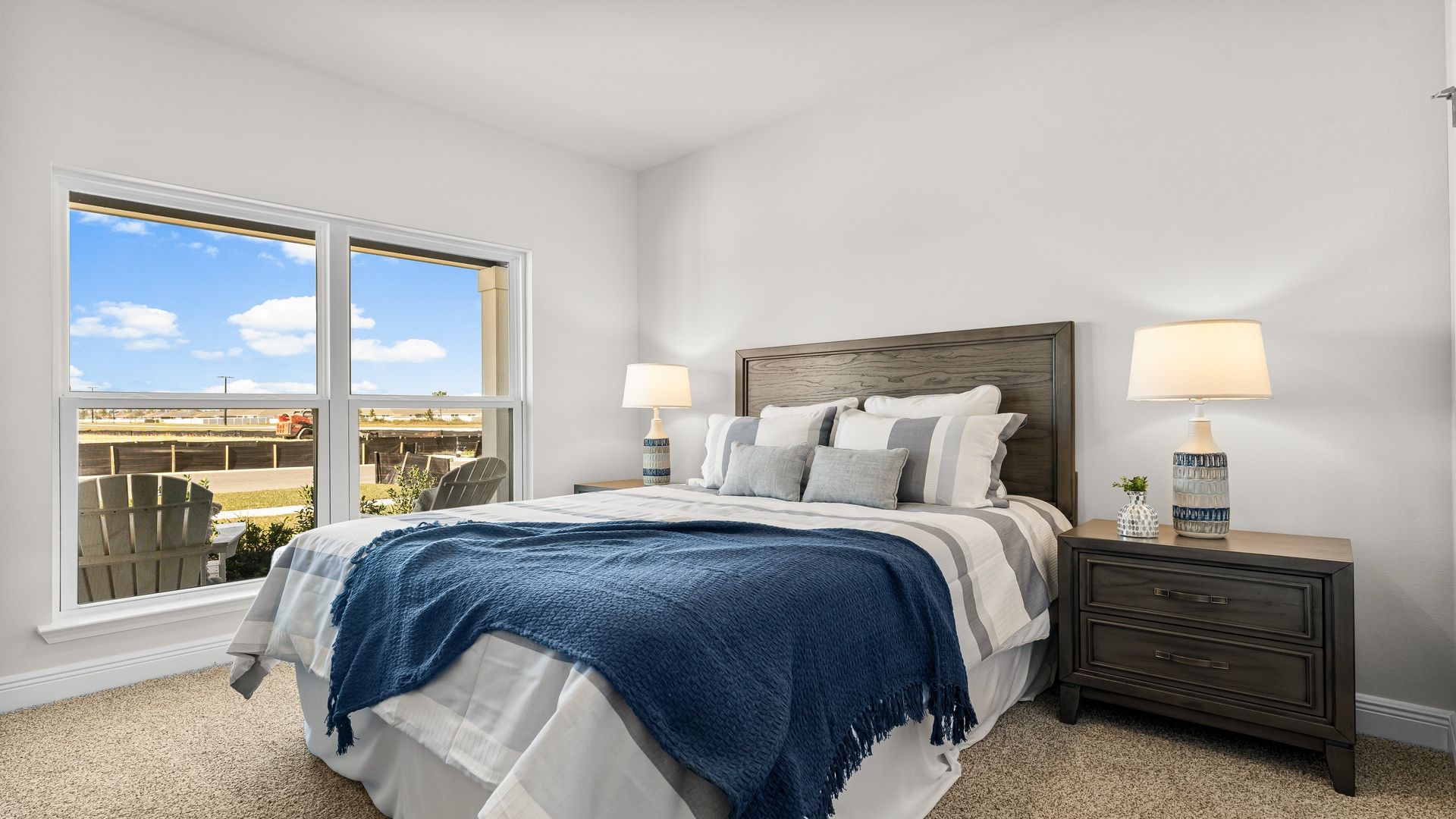 Bedroom with carpet floors and large double window.