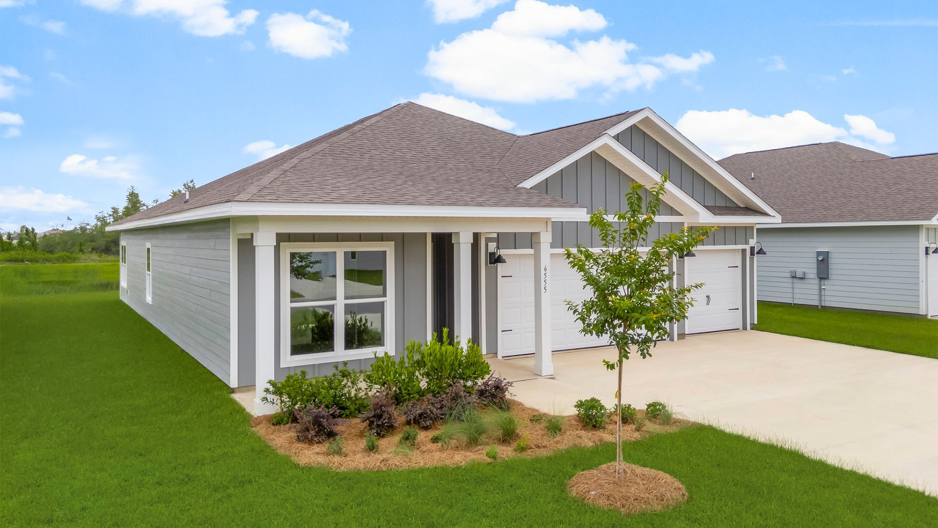 Madison floor plan with 3 car garage and covered front porch.